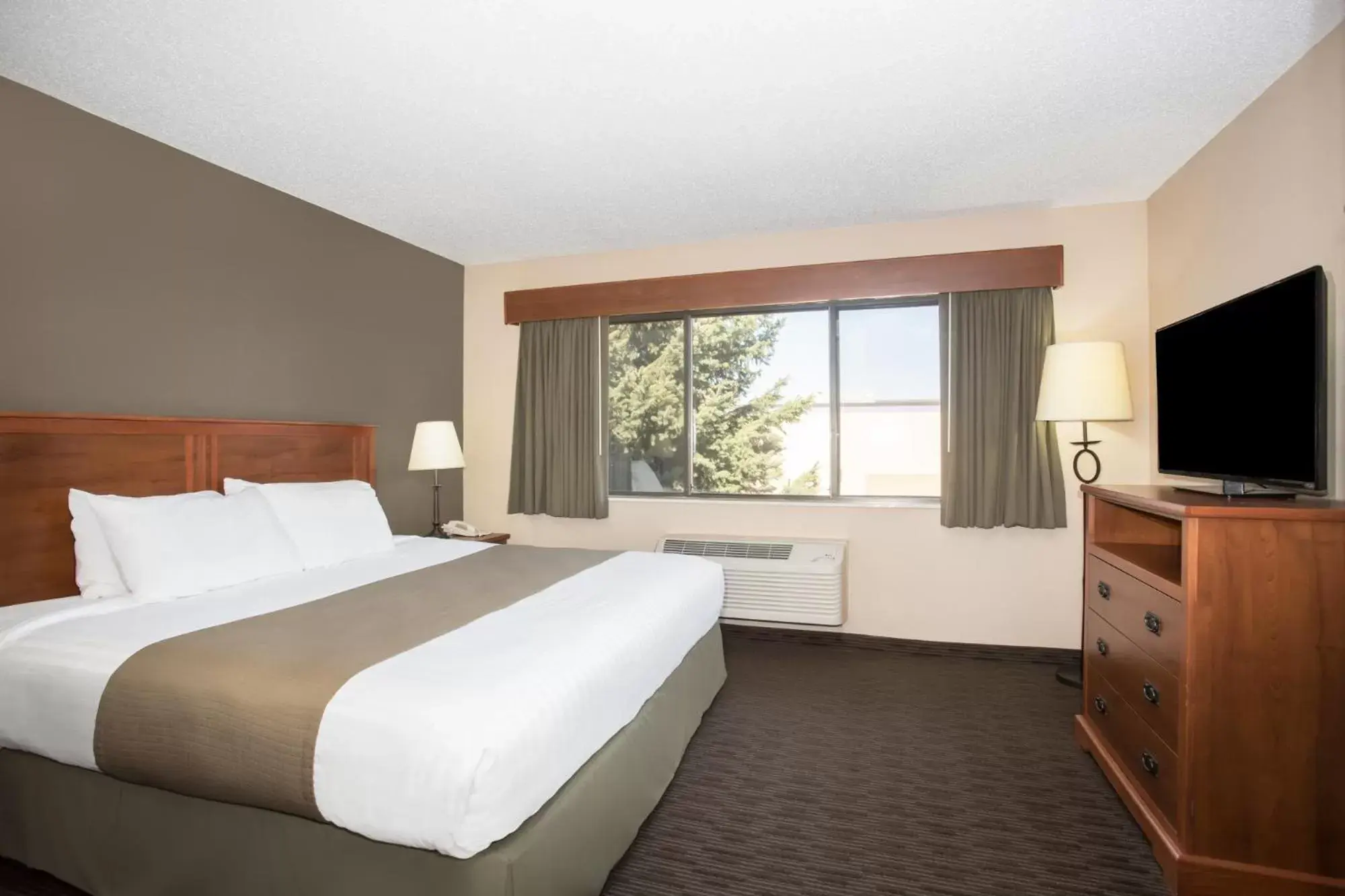 Bed in AmericInn by Wyndham Sioux City