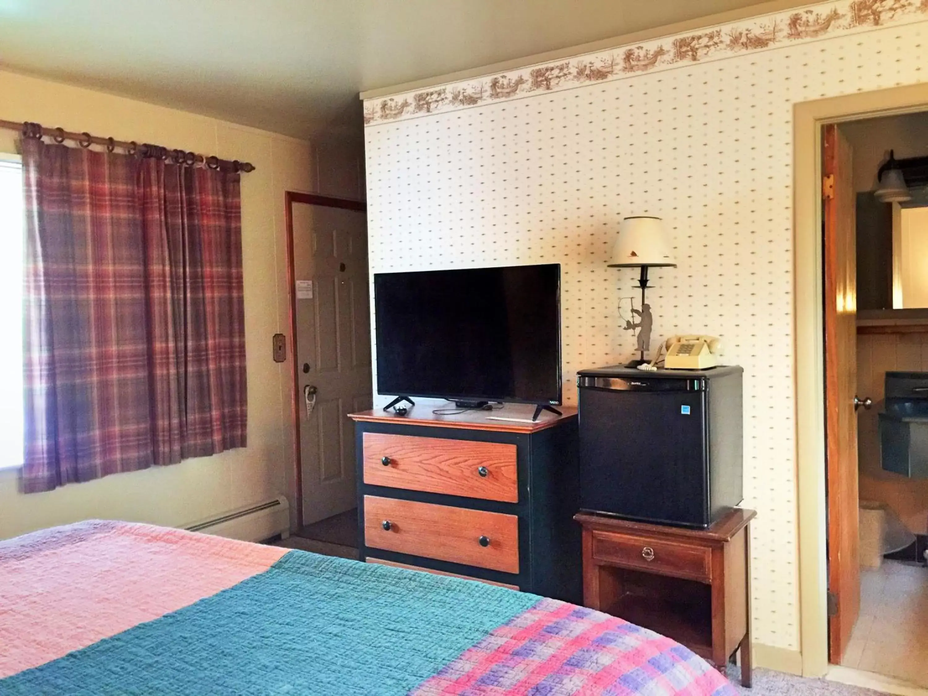 Bed, TV/Entertainment Center in Hungry Trout Resort