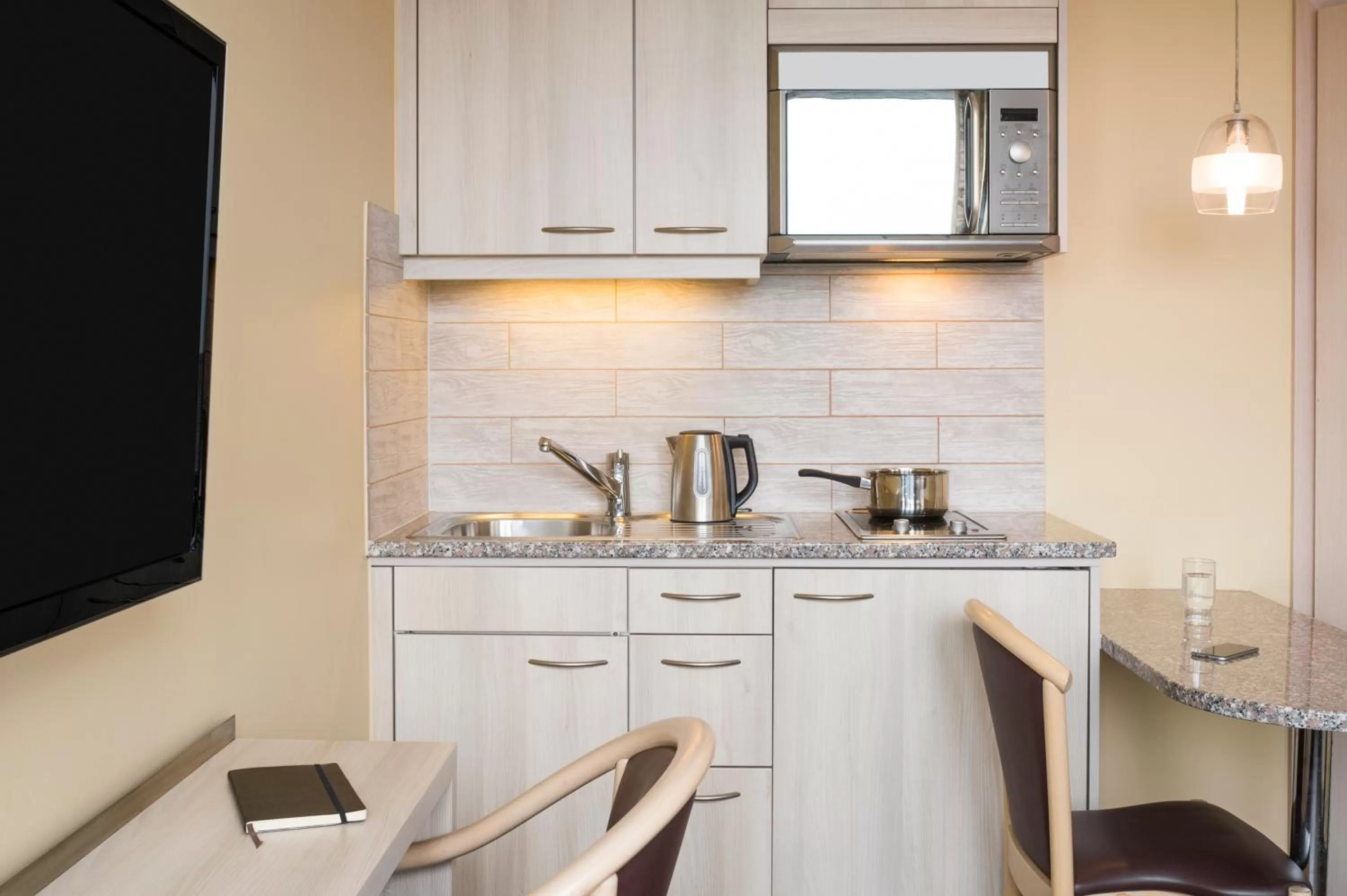 Kitchen or kitchenette in Aparthotel Adagio Genève Mont-Blanc