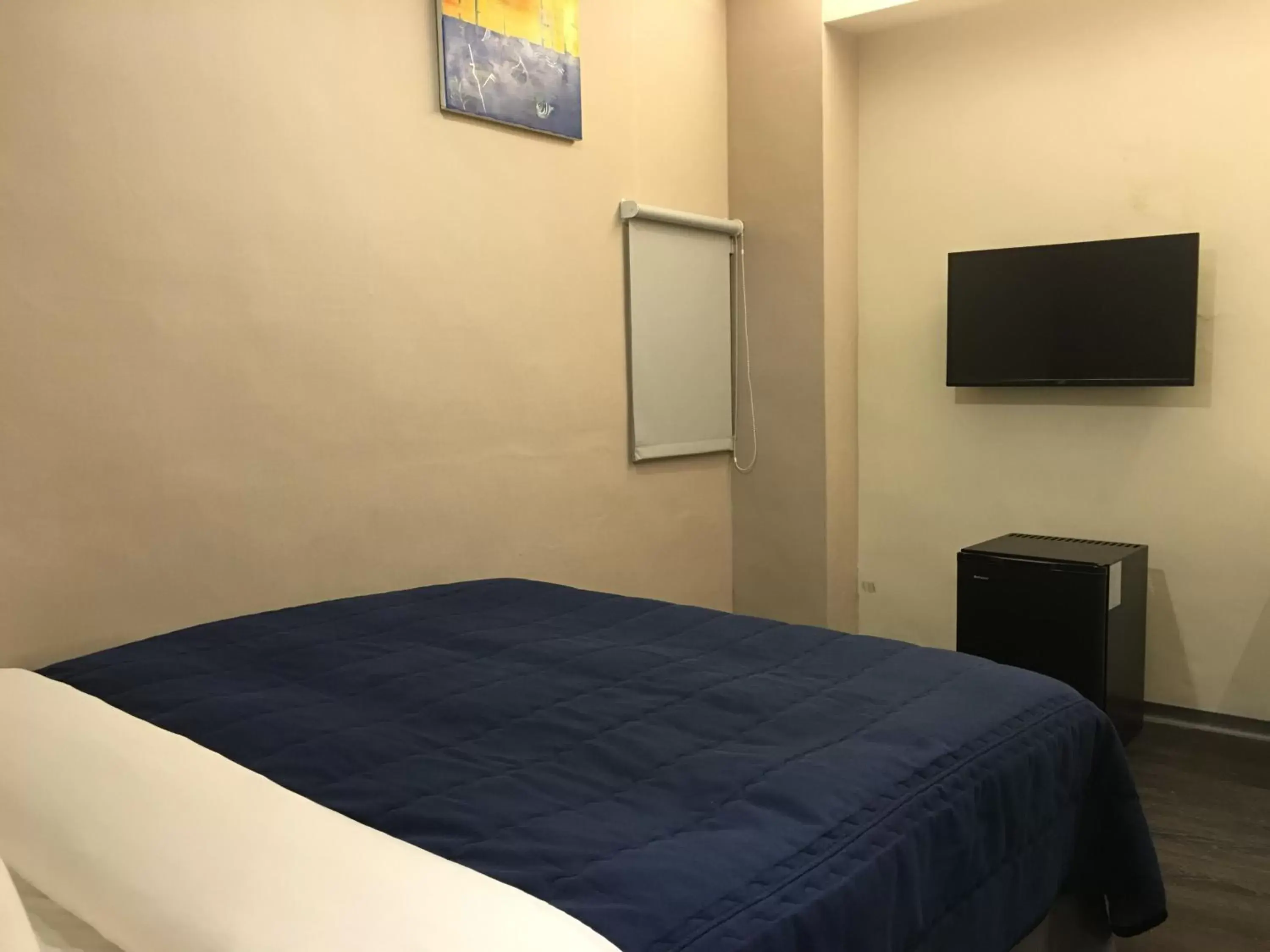 Bed, TV/Entertainment Center in Bulowan Hotel