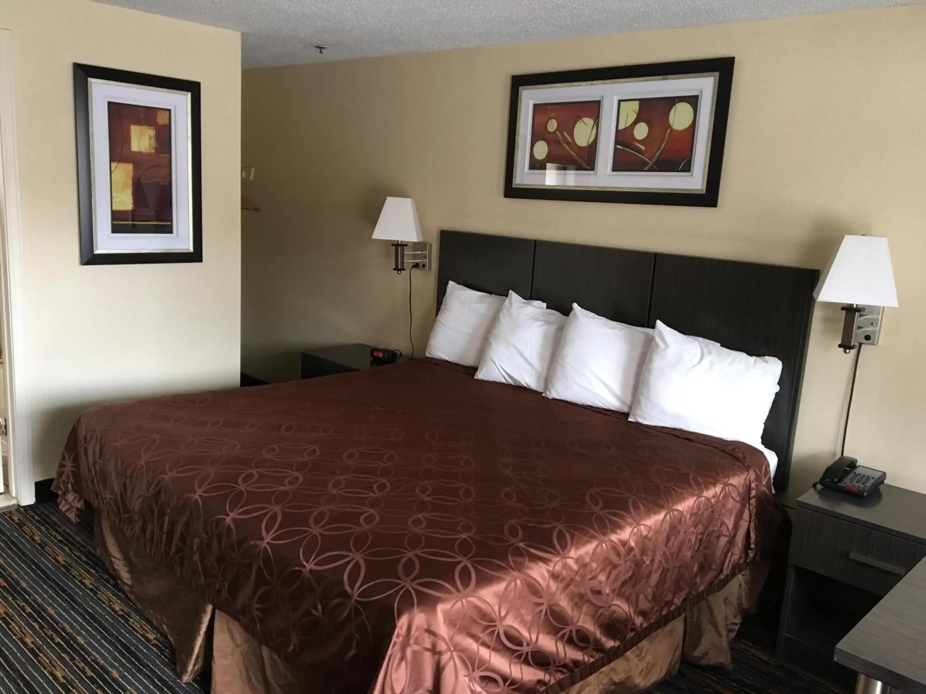 Bed in Whitney Inn & Suites