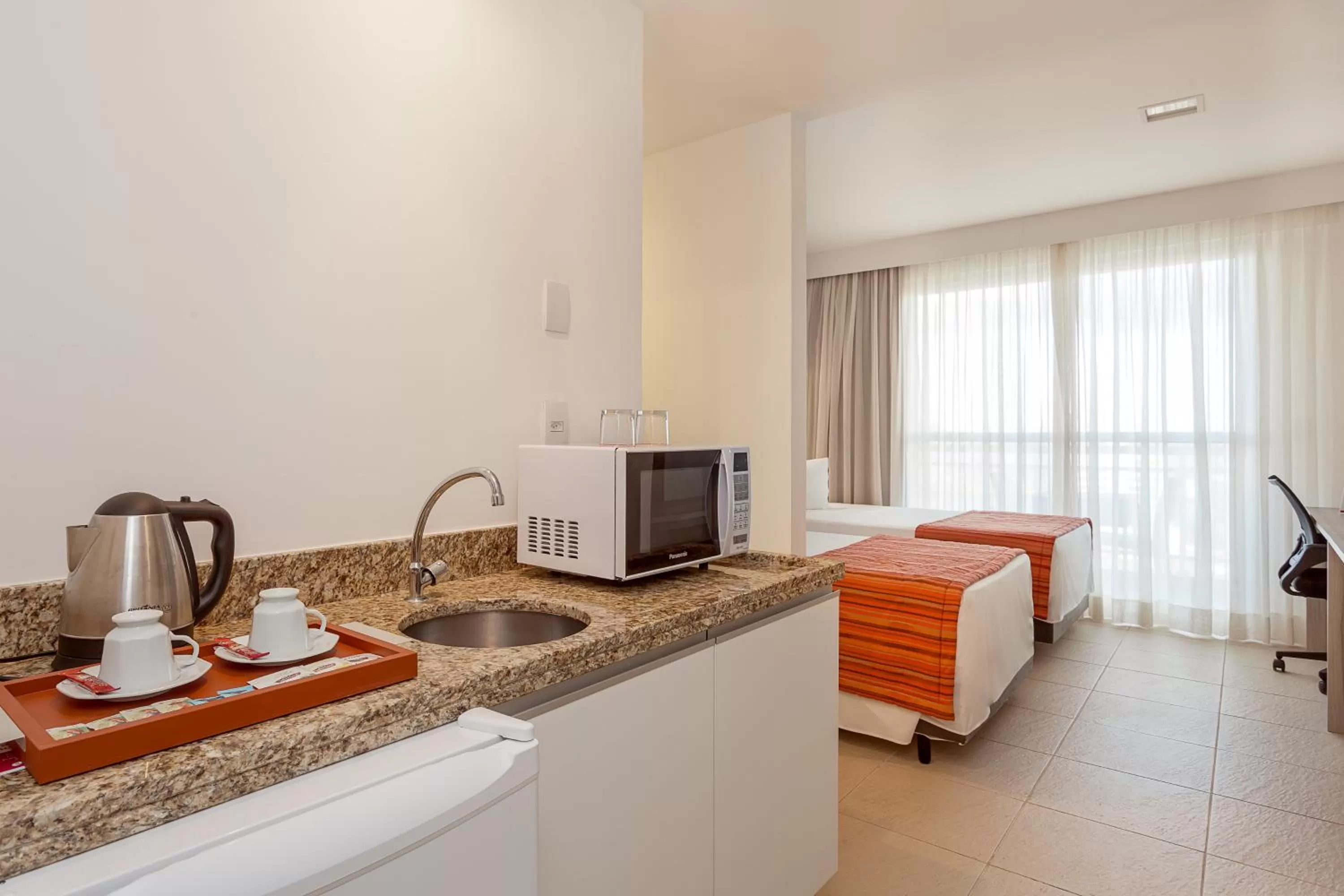 Bed in Ramada by Wyndham Macae Hotel & Suites