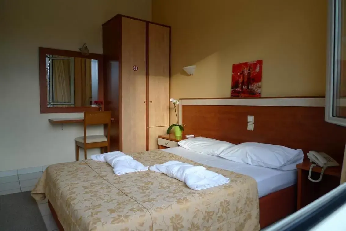 Bed in IKAROS Hotel