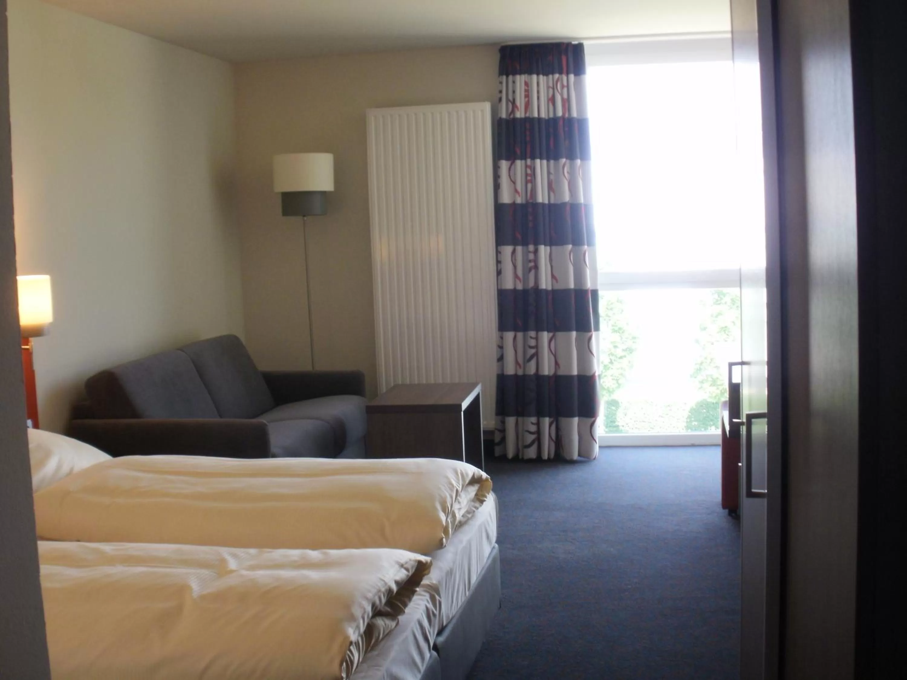 Photo of the whole room, Bed in iQ-Hotel Ulm