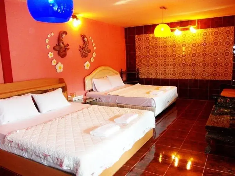 Bed in Suksomjai Hotel