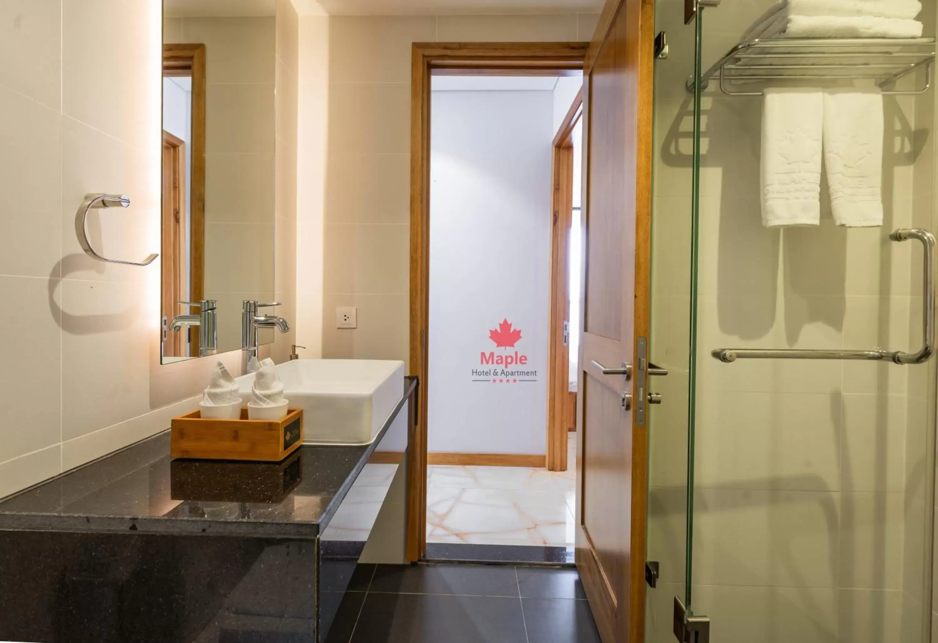 Bathroom in Maple Hotel & Apartment