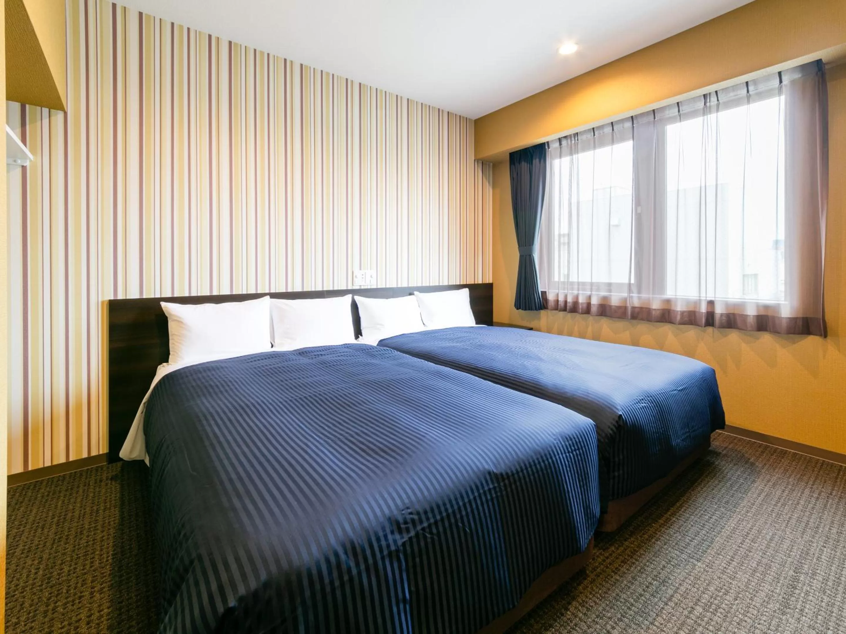 Bed in HOTEL LiVEMAX Sendai Aobadori