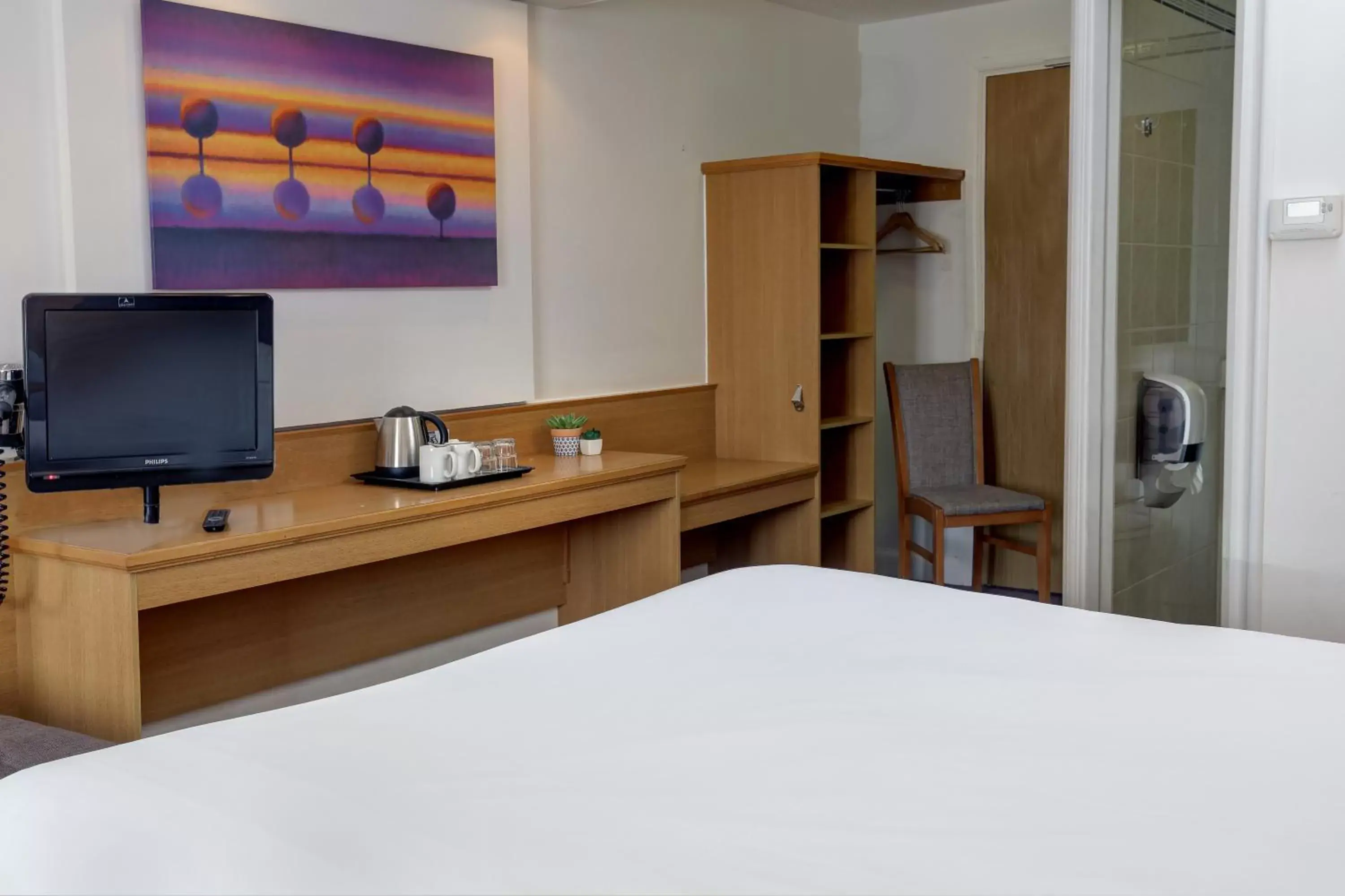 Bed, TV/Entertainment Center in Orchid Epsom; Sure Hotel Collection by Best Western