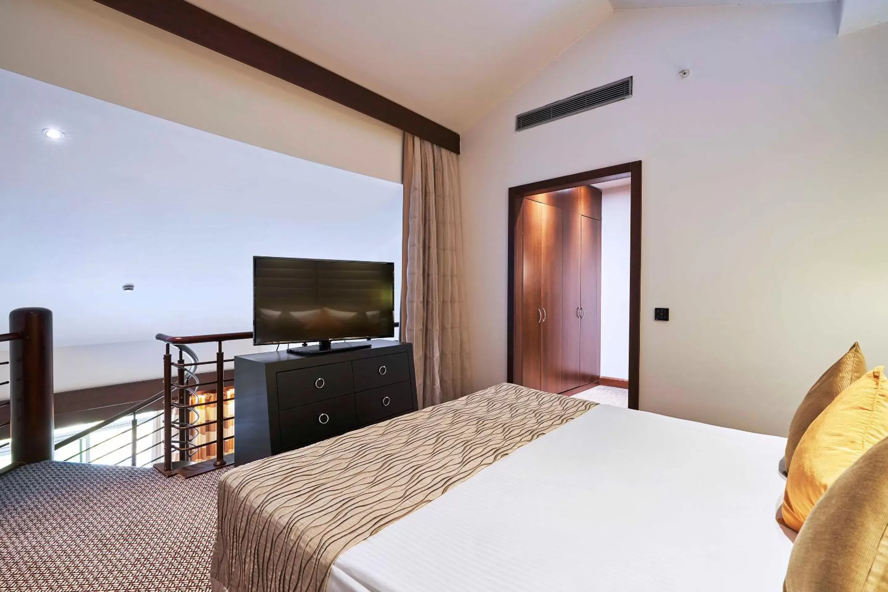 Bed, TV/Entertainment Center in Calista Luxury Resort