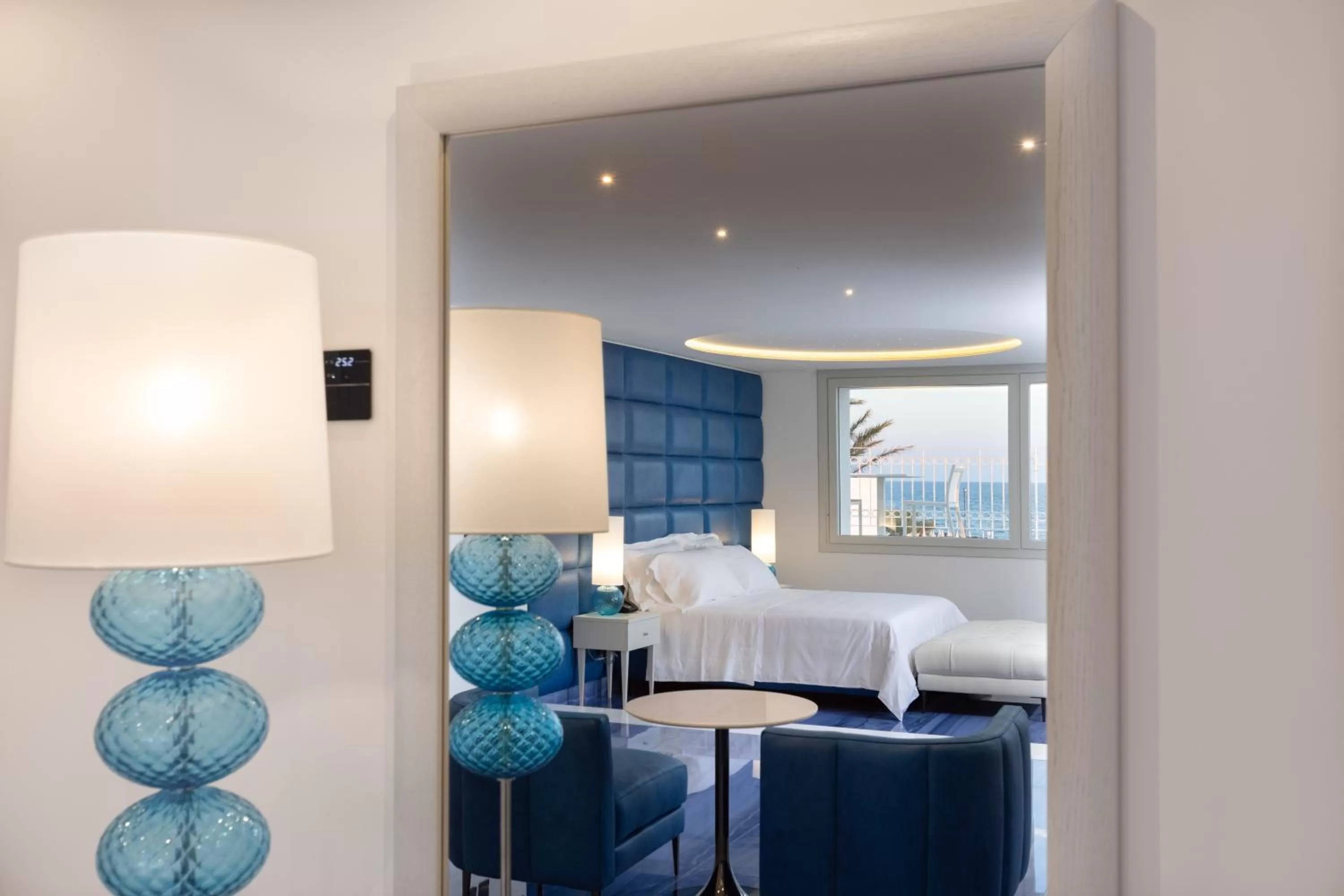 Seating area, Bed in Grotta Palazzese Beach Hotel