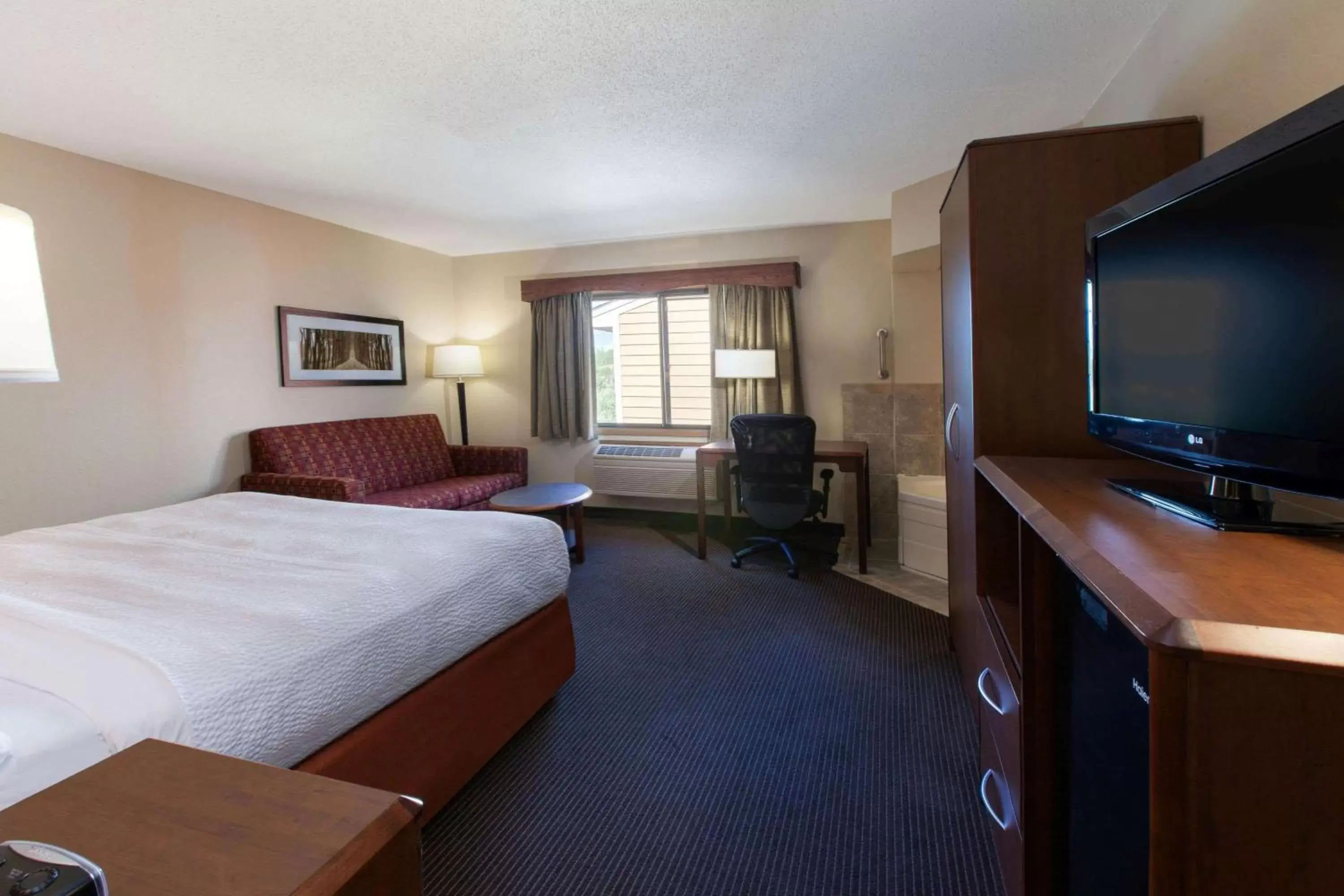 Photo of the whole room, TV/Entertainment Center in AmericInn by Wyndham Iron River