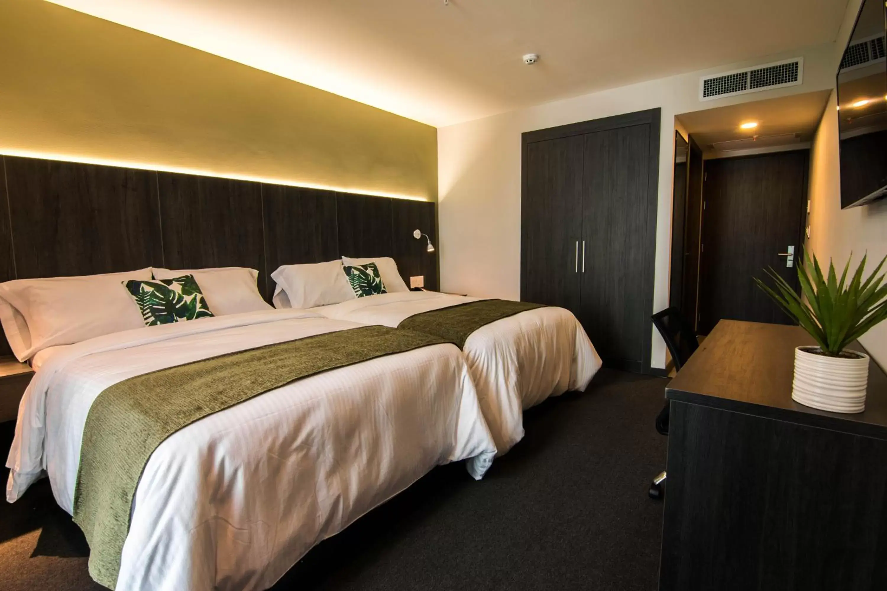 Bed in Innfiniti Hotel & Suites