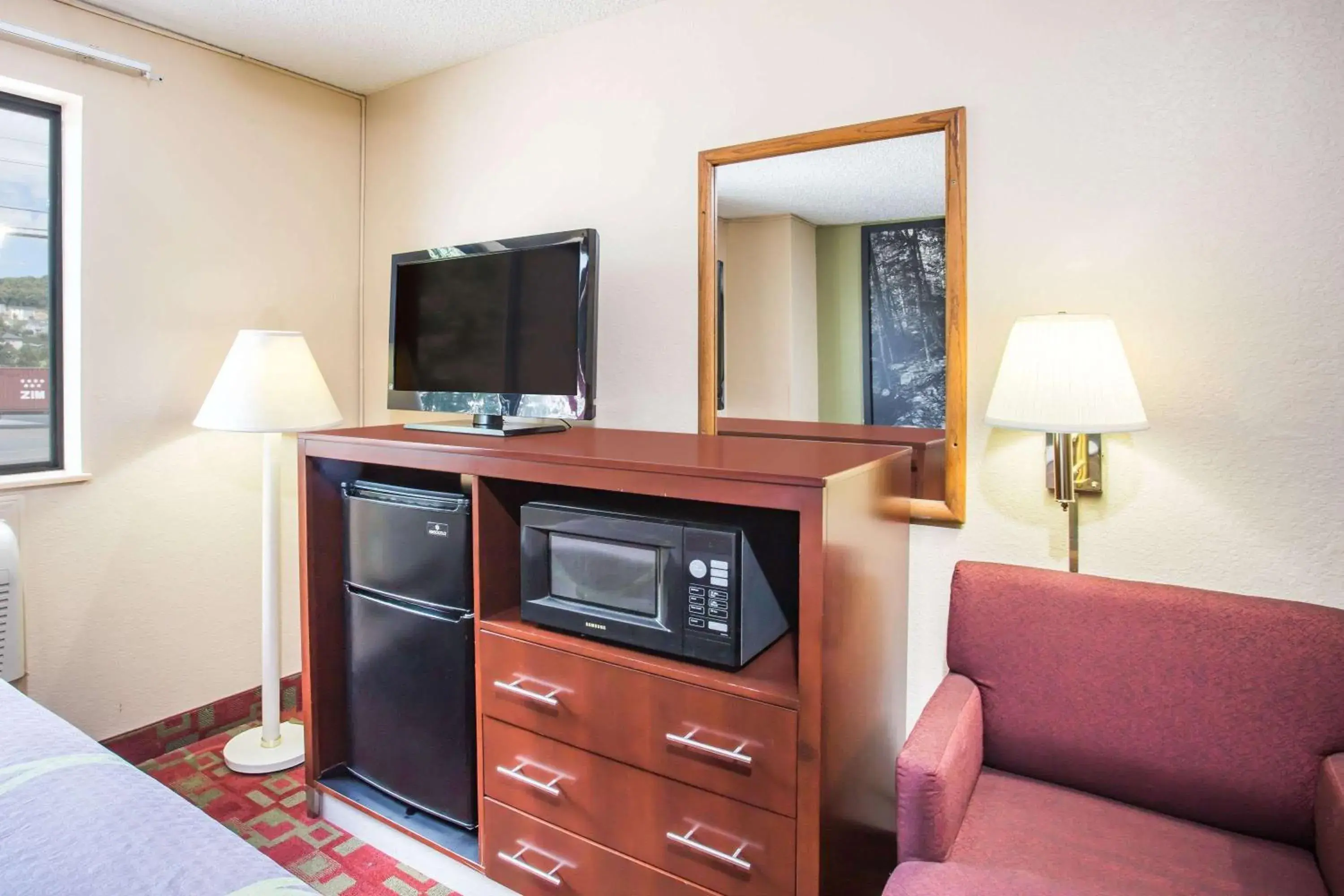 Photo of the whole room, TV/Entertainment Center in Super 8 by Wyndham Harrisonburg