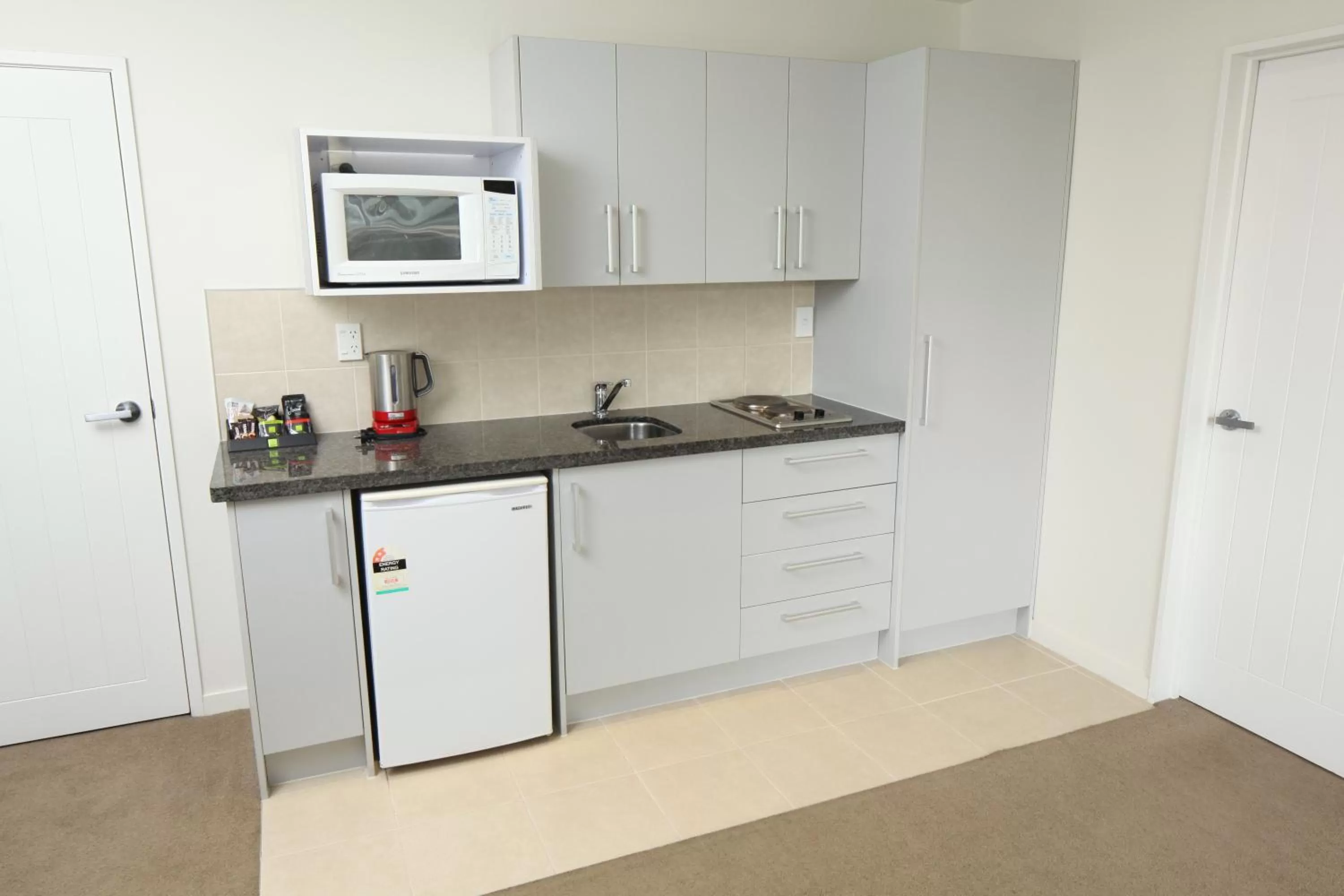 Kitchen or kitchenette in Alpha Motel with Spa-Bath