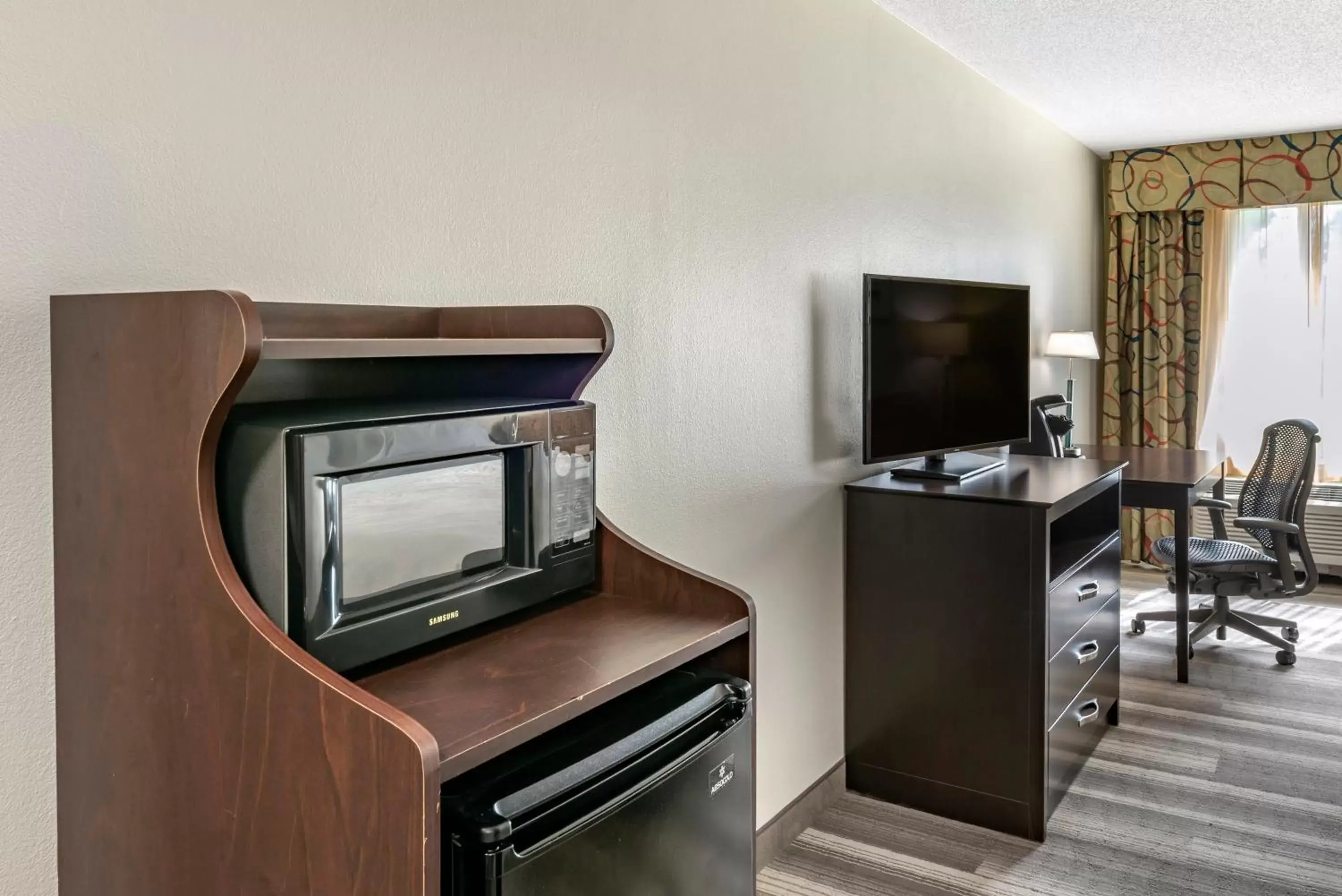 Photo of the whole room, TV/Entertainment Center in Holiday Inn Express Hotel & Suites Cincinnati-Blue Ash, an IHG Hotel