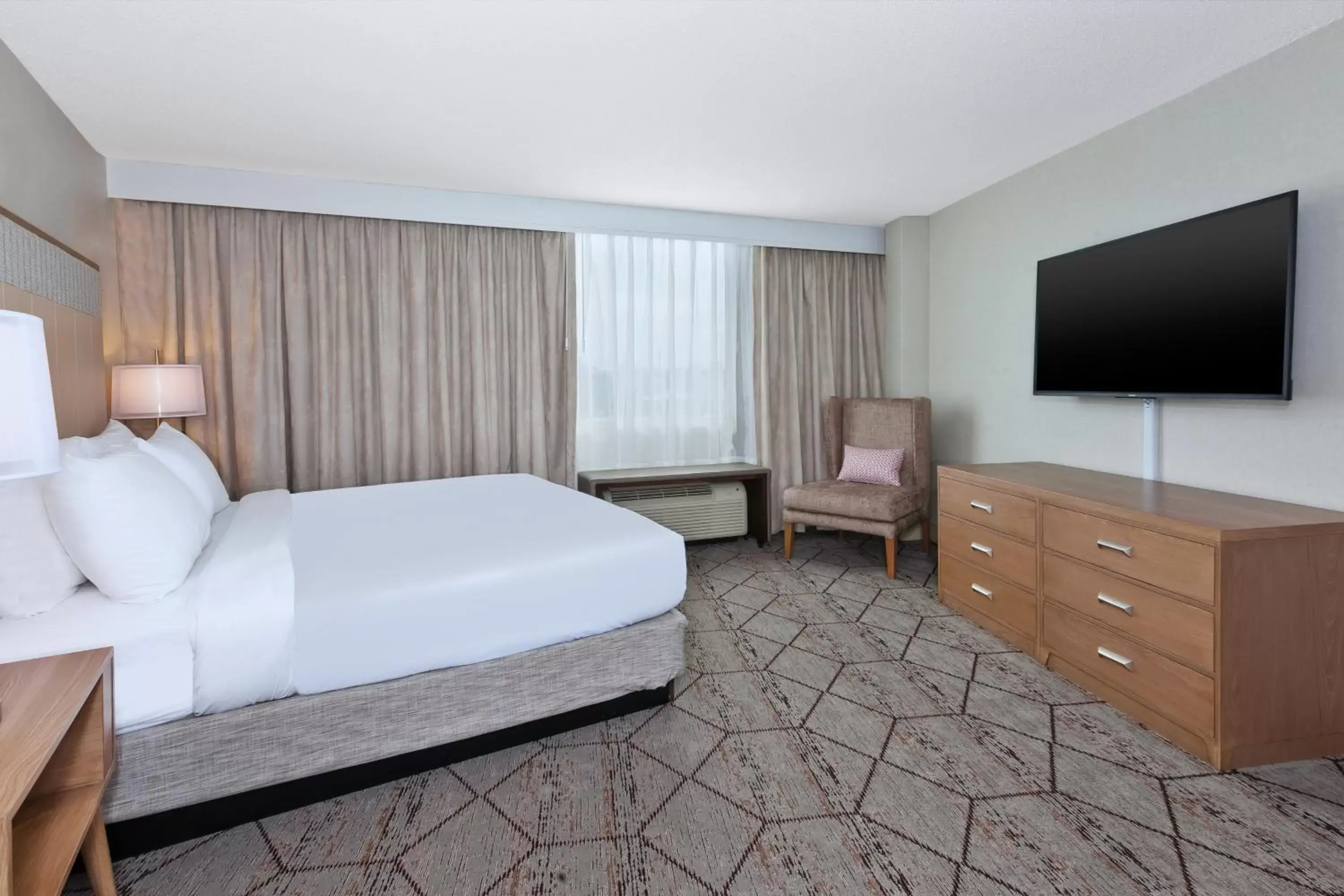 Bed in Crowne Plaza Syracuse, an IHG Hotel