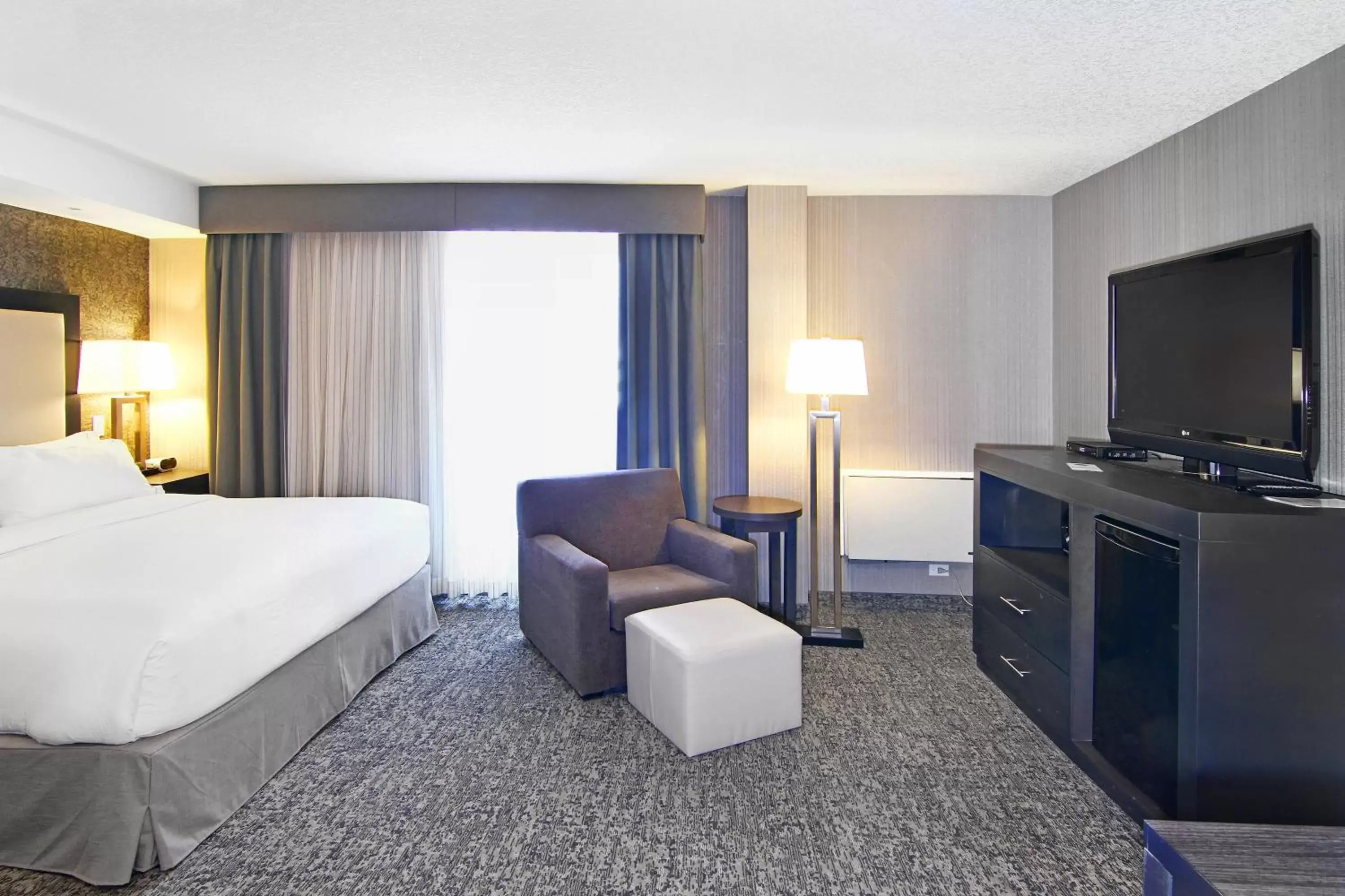 Photo of the whole room, TV/Entertainment Center in Holiday Inn Express and Suites Calgary, an IHG Hotel