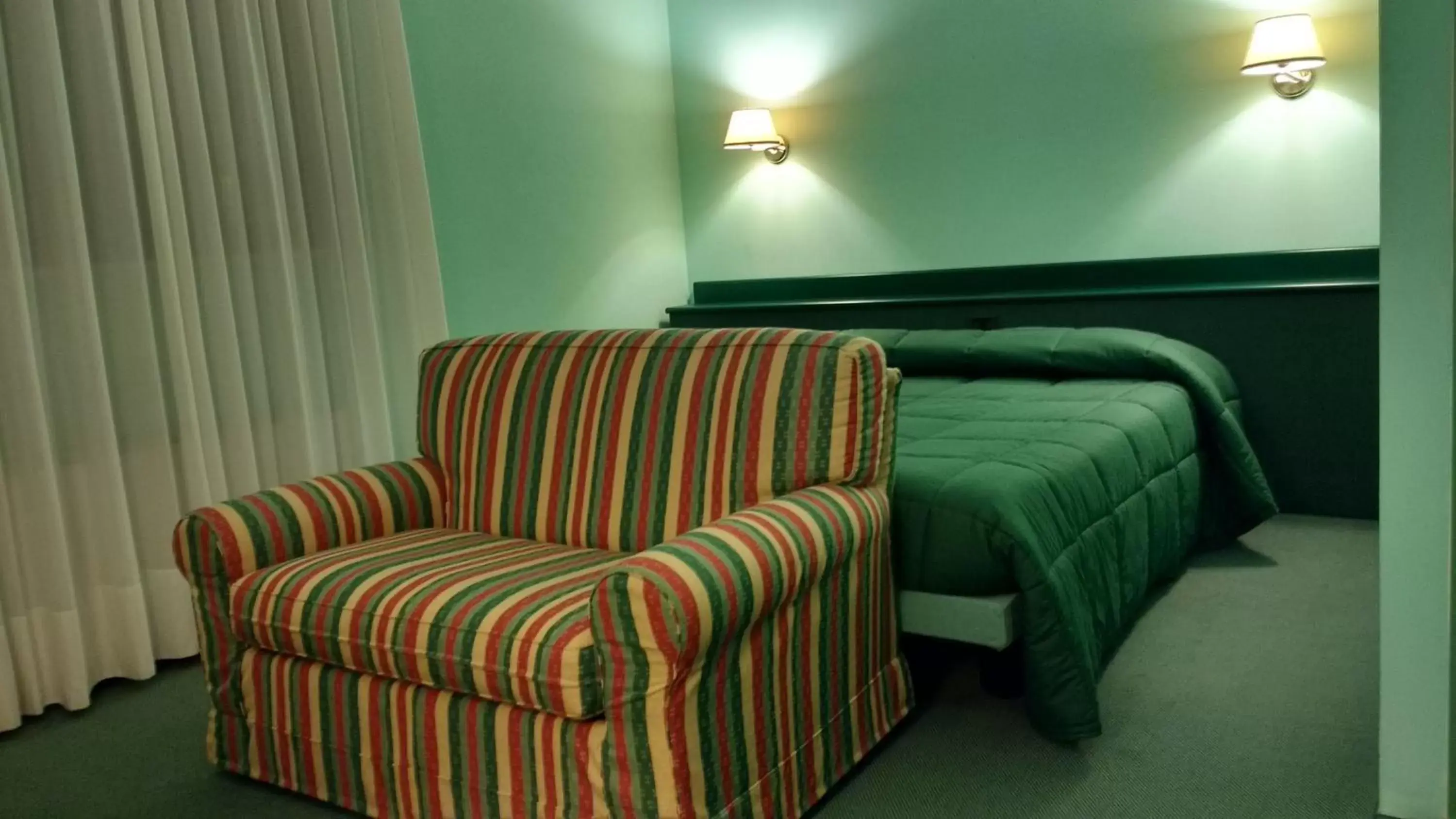 Bed, Seating Area in Hotel La Goletta