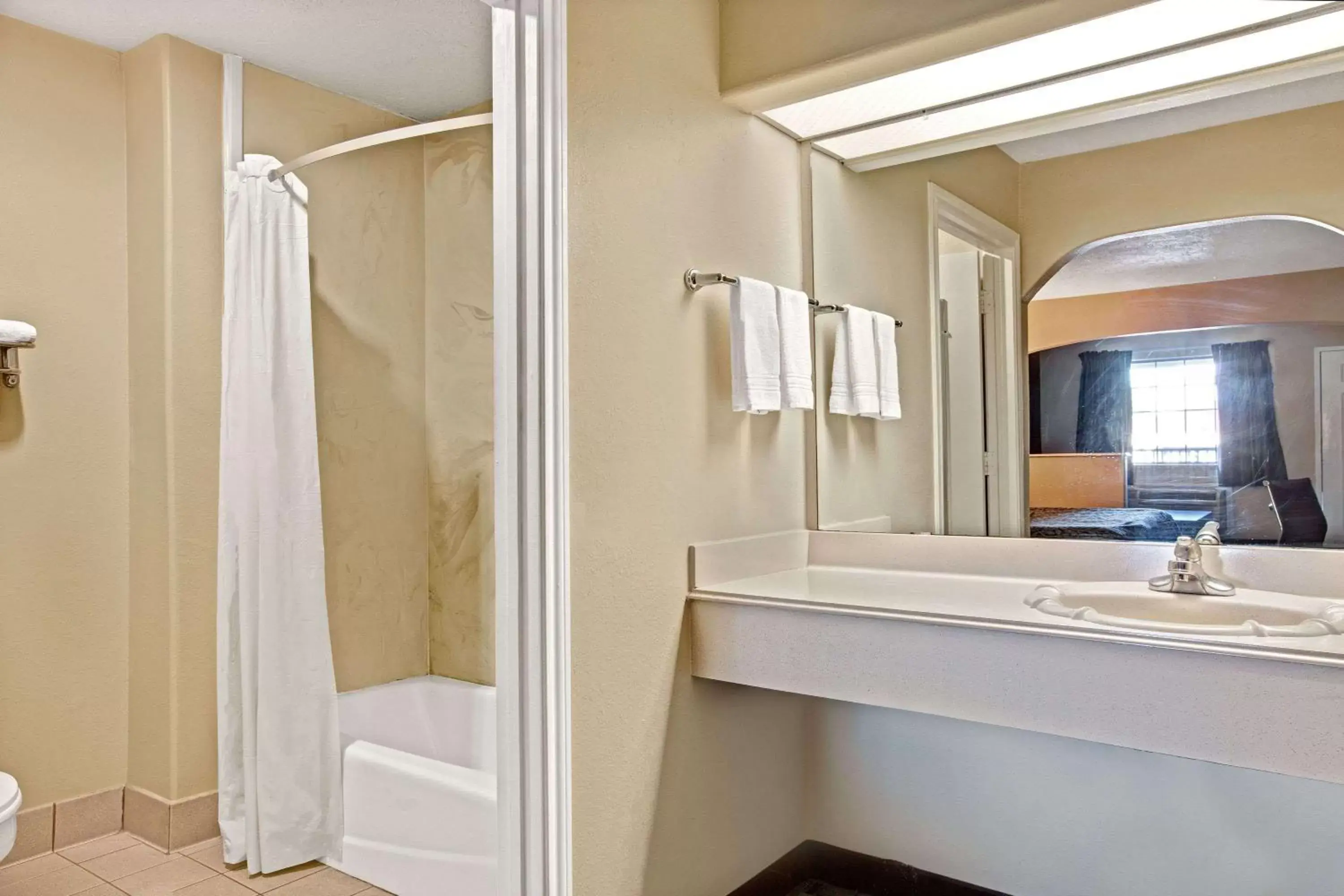 Bathroom in Days Inn & Suites by Wyndham Houston North - Spring