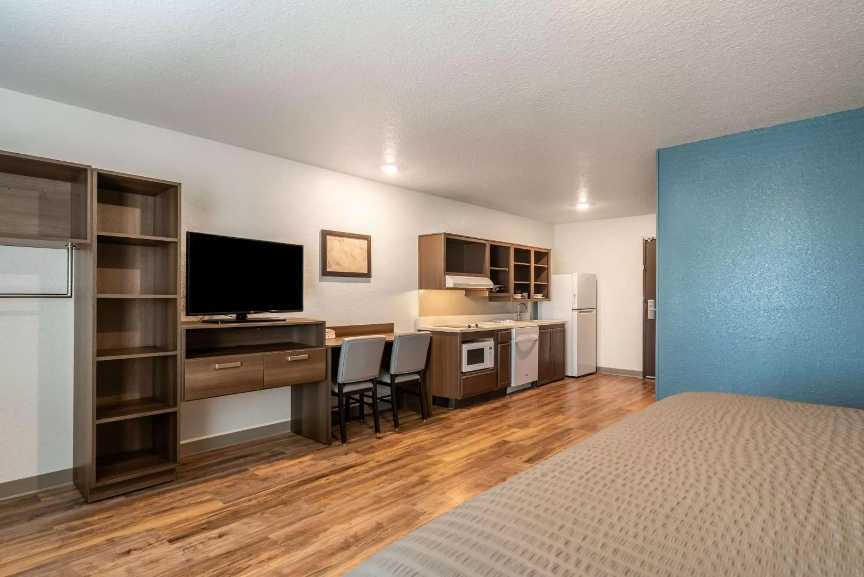 Photo of the whole room, TV/Entertainment Center in WoodSpring Suites Sanford North I-4 Orlando Area