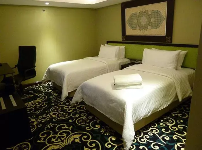 Bed in Mudzaffar Hotel