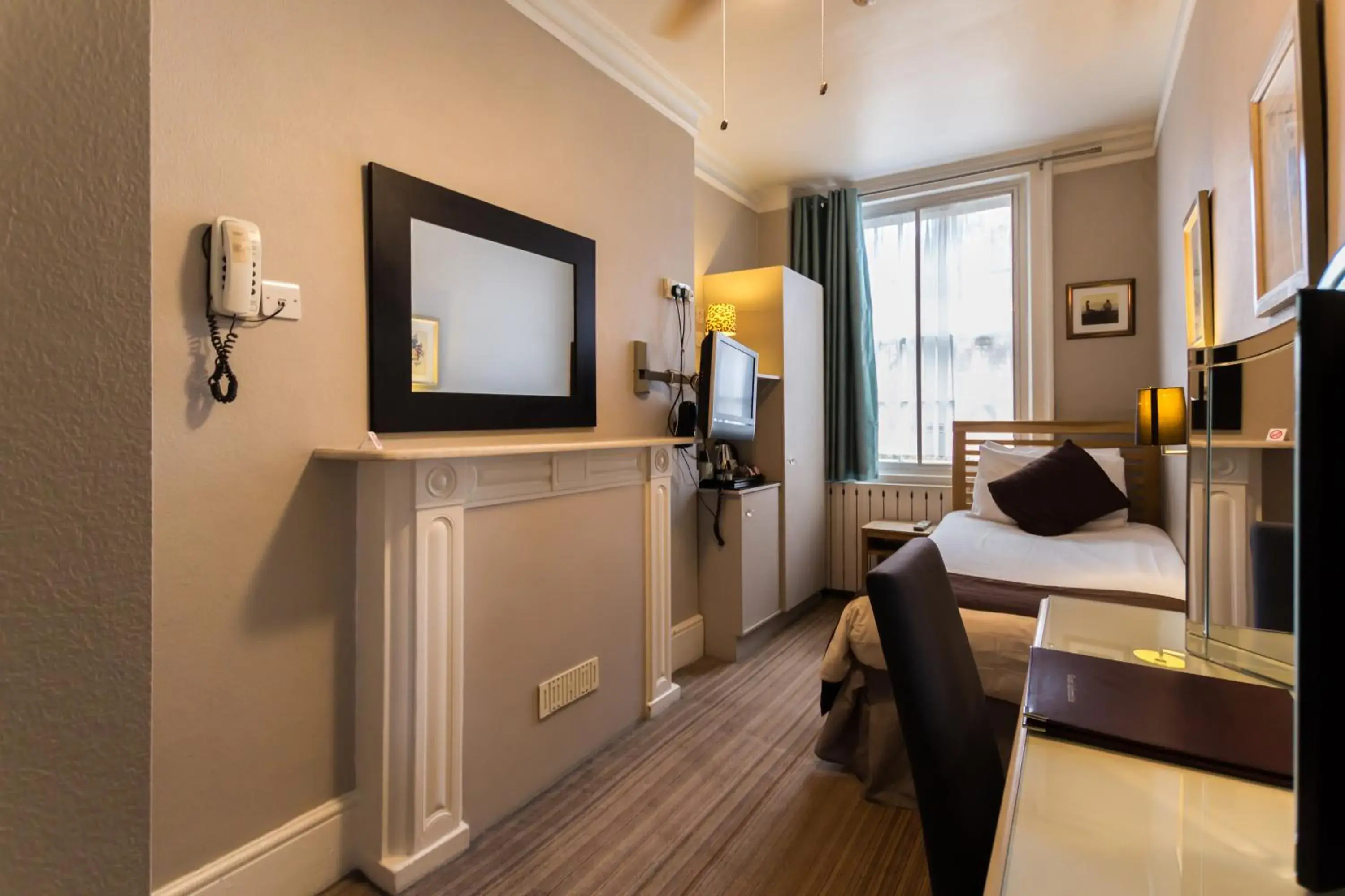 Bedroom, TV/Entertainment Center in Arosfa Hotel London by Compass Hospitality