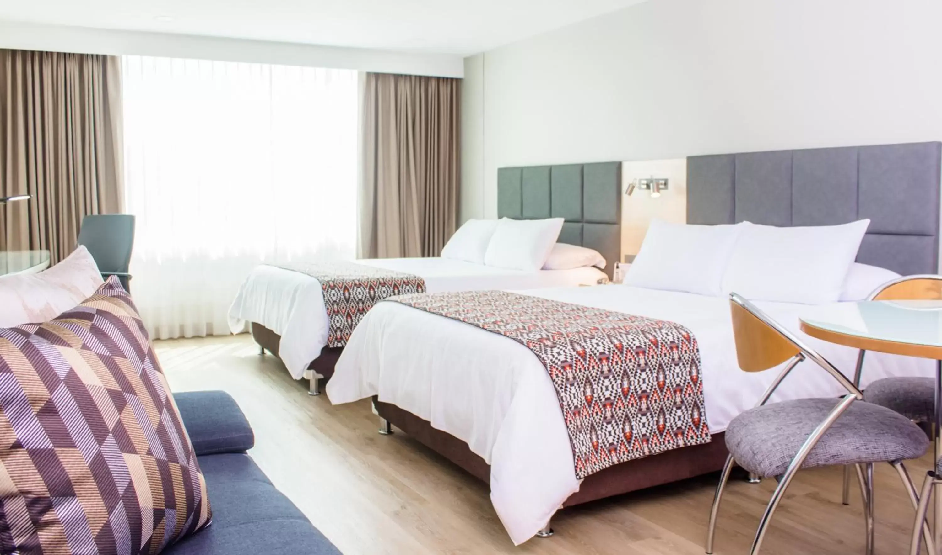 Seating area, Bed in Novelty Suites Hotel