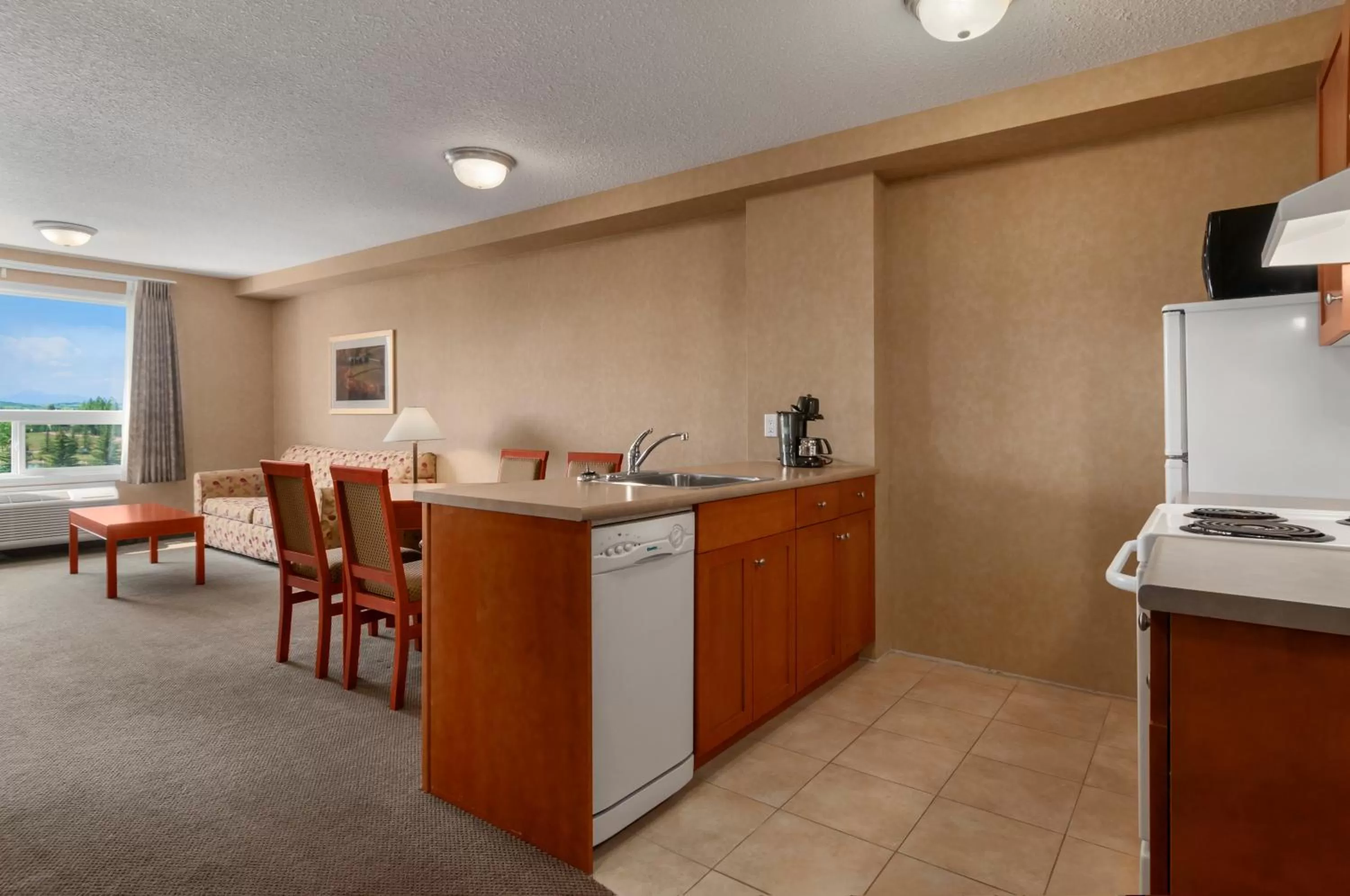 Kitchen or kitchenette in Days Inn & Suites by Wyndham Cochrane