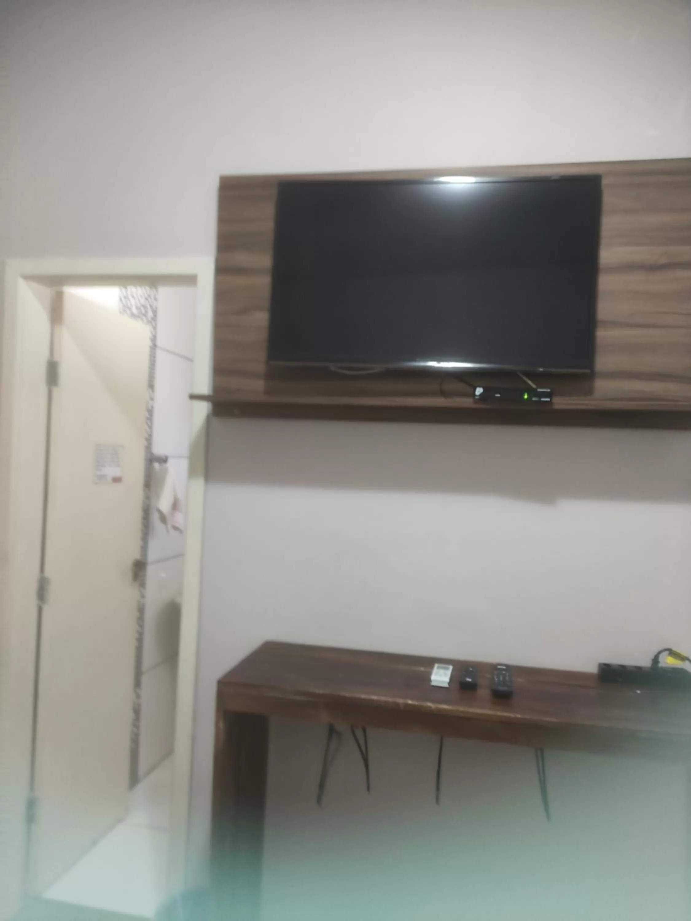 TV/Entertainment Center in Pousada da Gi Suítes e Turismo