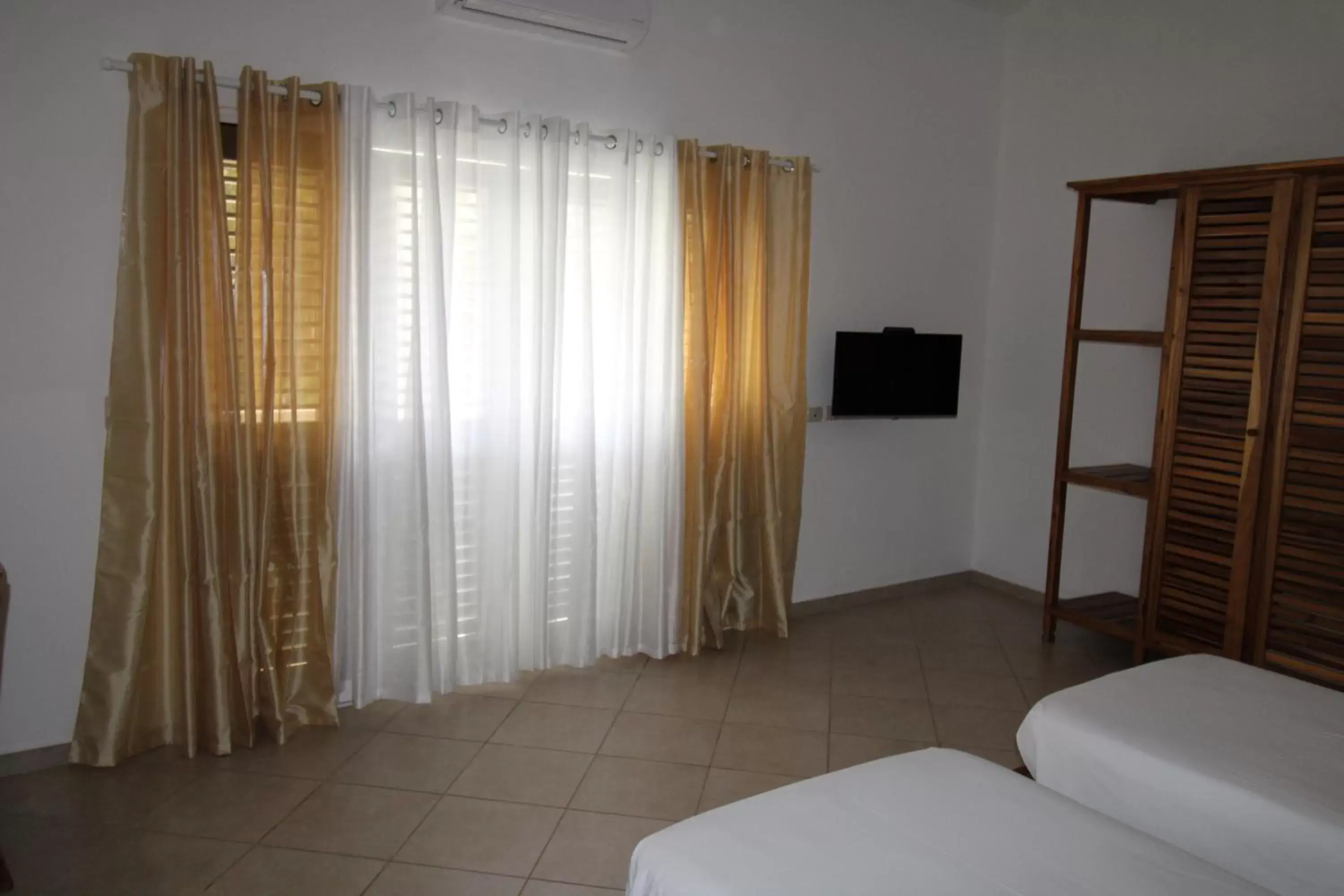 Bed, TV/Entertainment Center in Albachiara Hotel - Las Terrenas