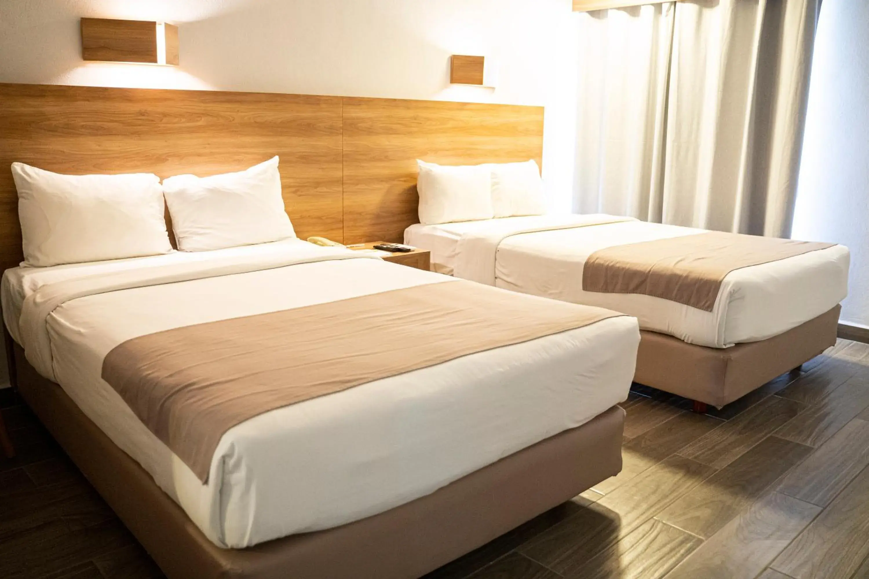 Bed in La Posada Hotel y Suites