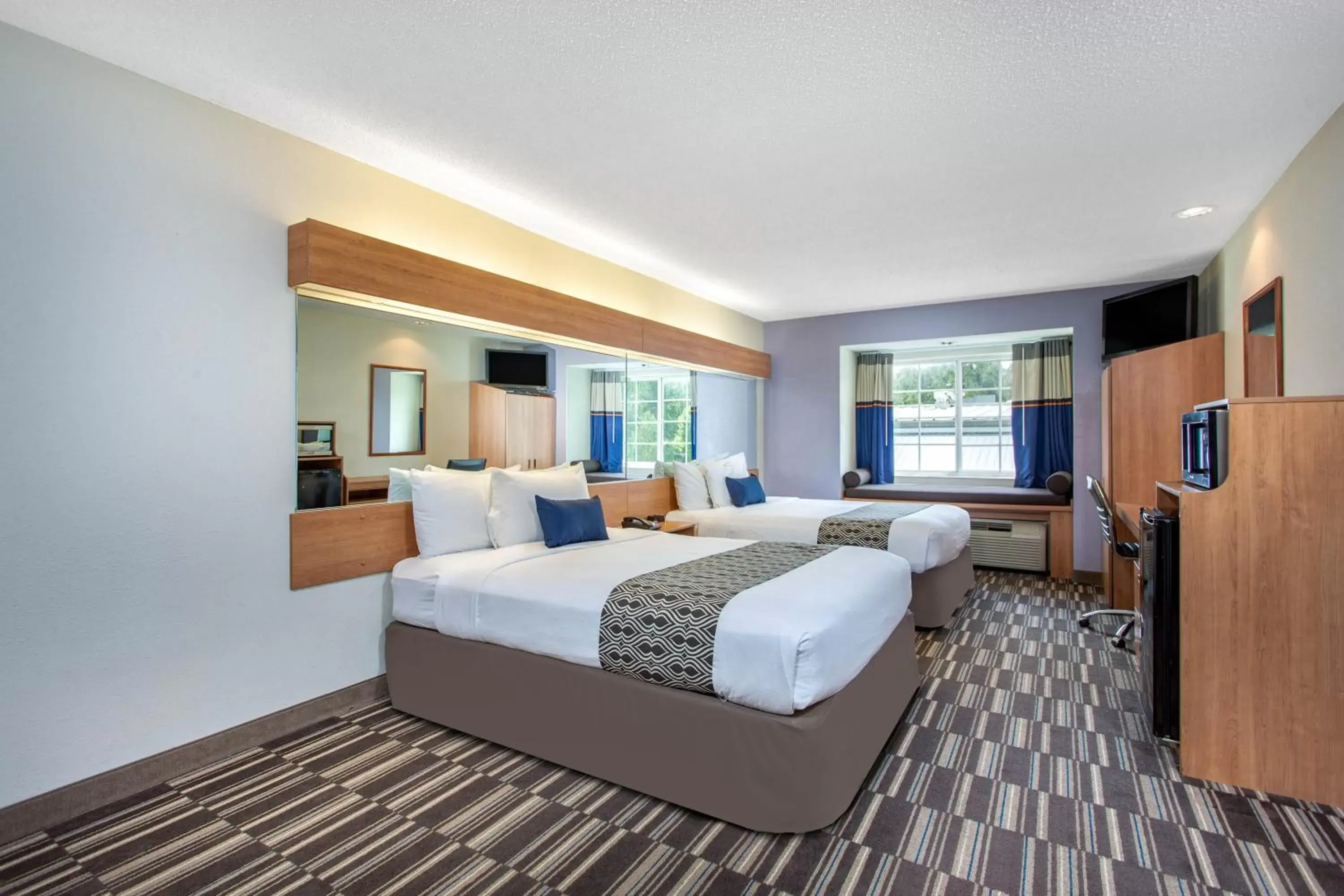 Bed in Microtel Inn & Suites by Wyndham Lillington/Campbell University