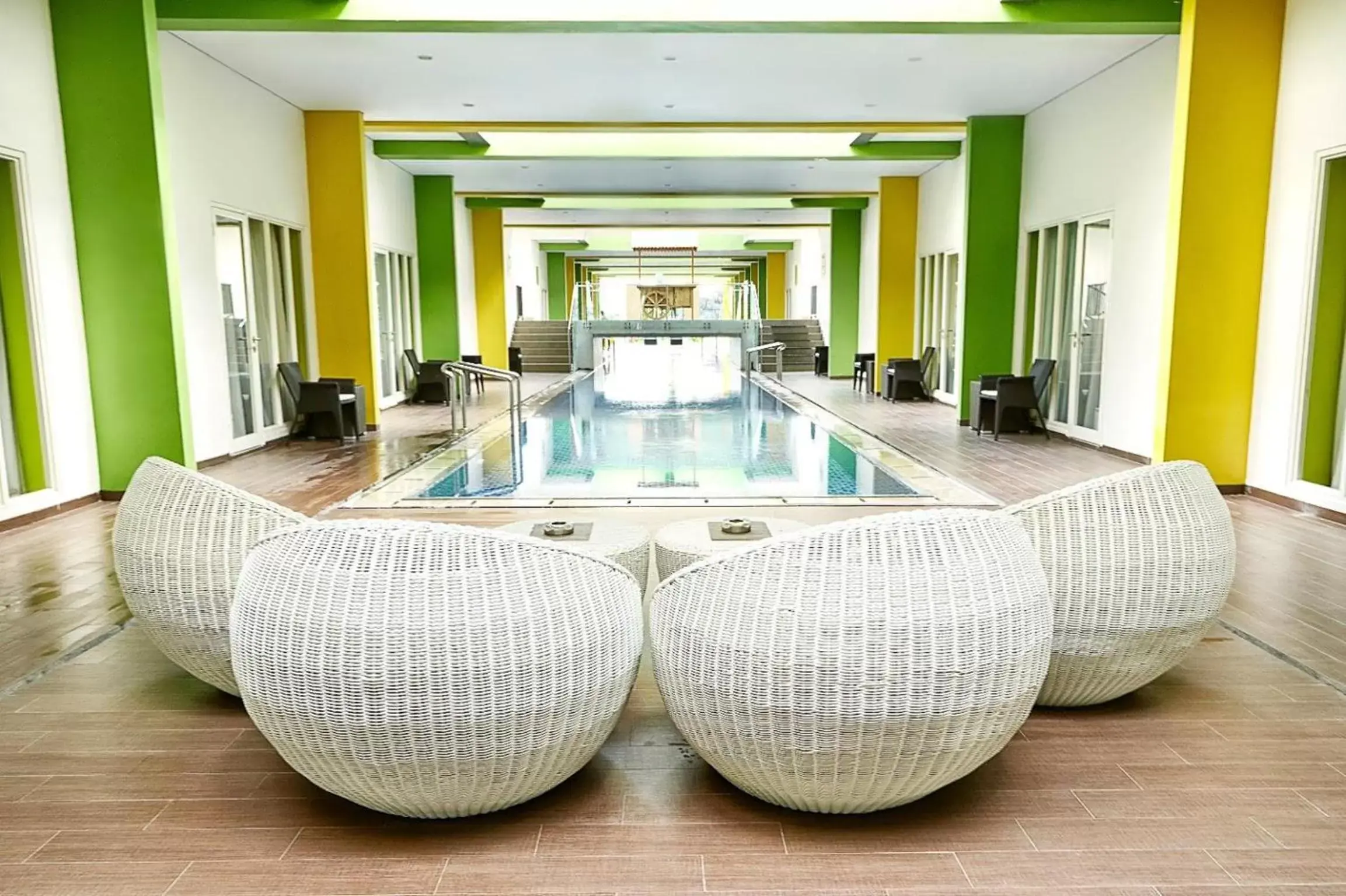 Seating area, Swimming Pool in MaxOneHotels at Resort Makassar