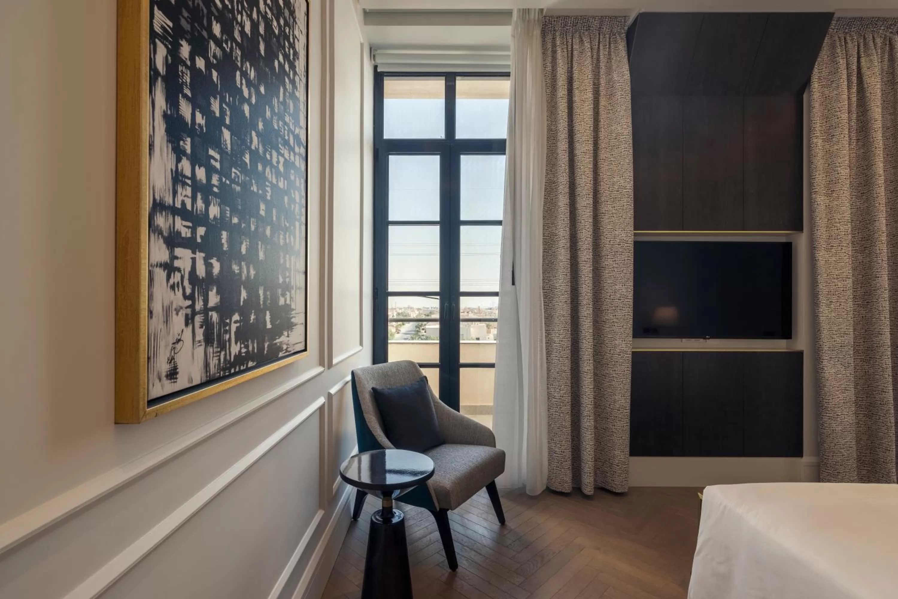 Seating area, Bed in Mansard Riyadh, a Radisson Collection Hotel