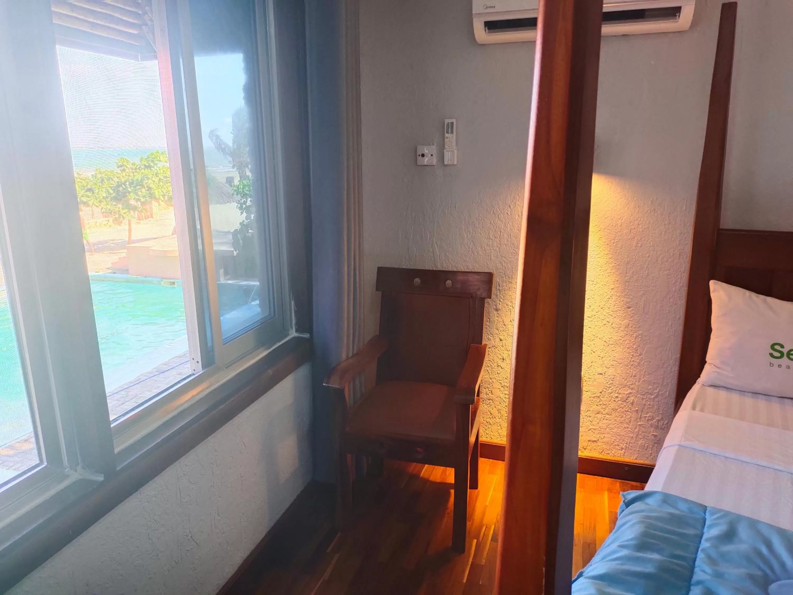 Bed, Seating Area in Serene Beach Resort