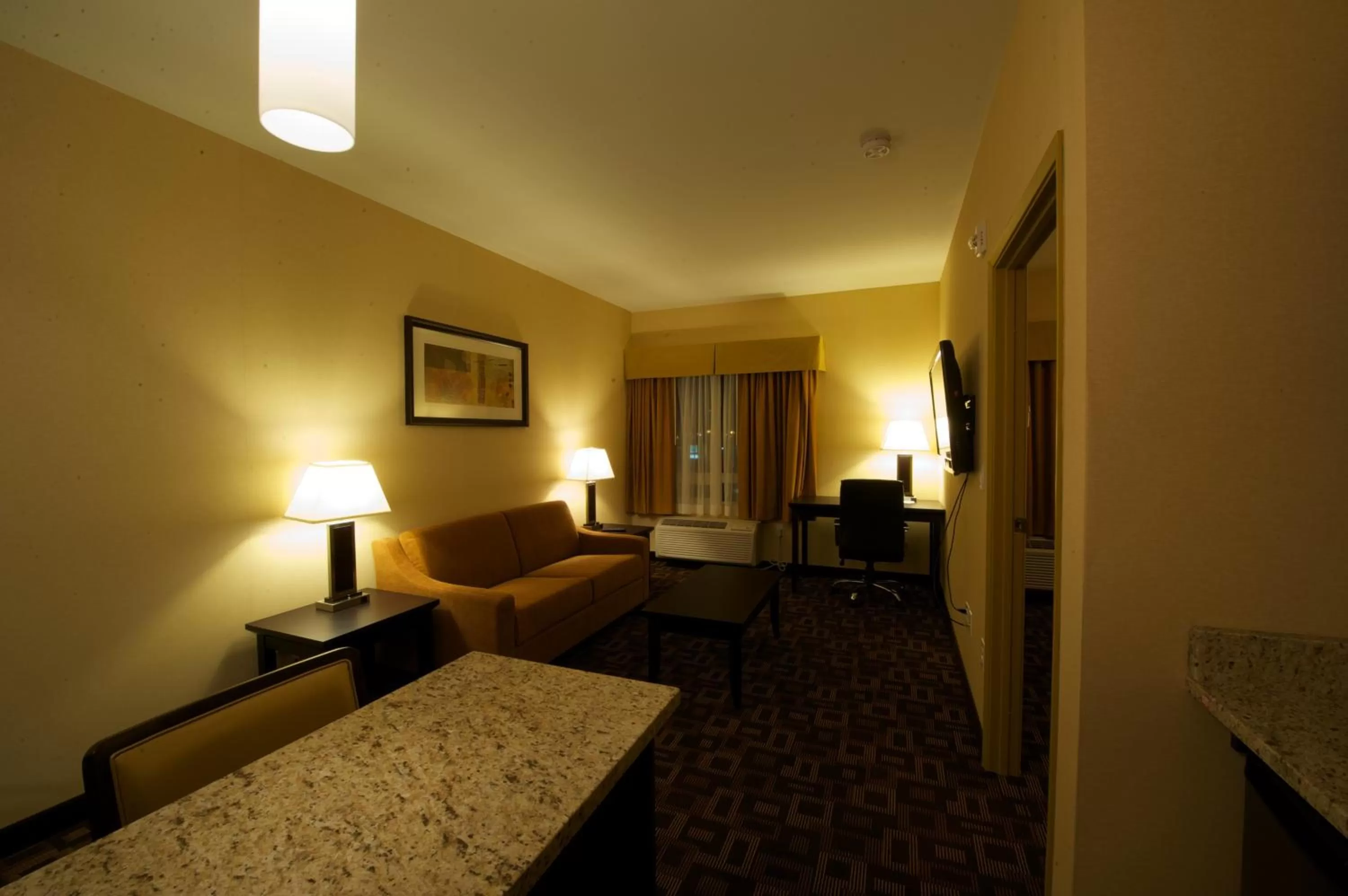Seating area, Bed in Days Inn & Suites by Wyndham Winnipeg Airport Manitoba