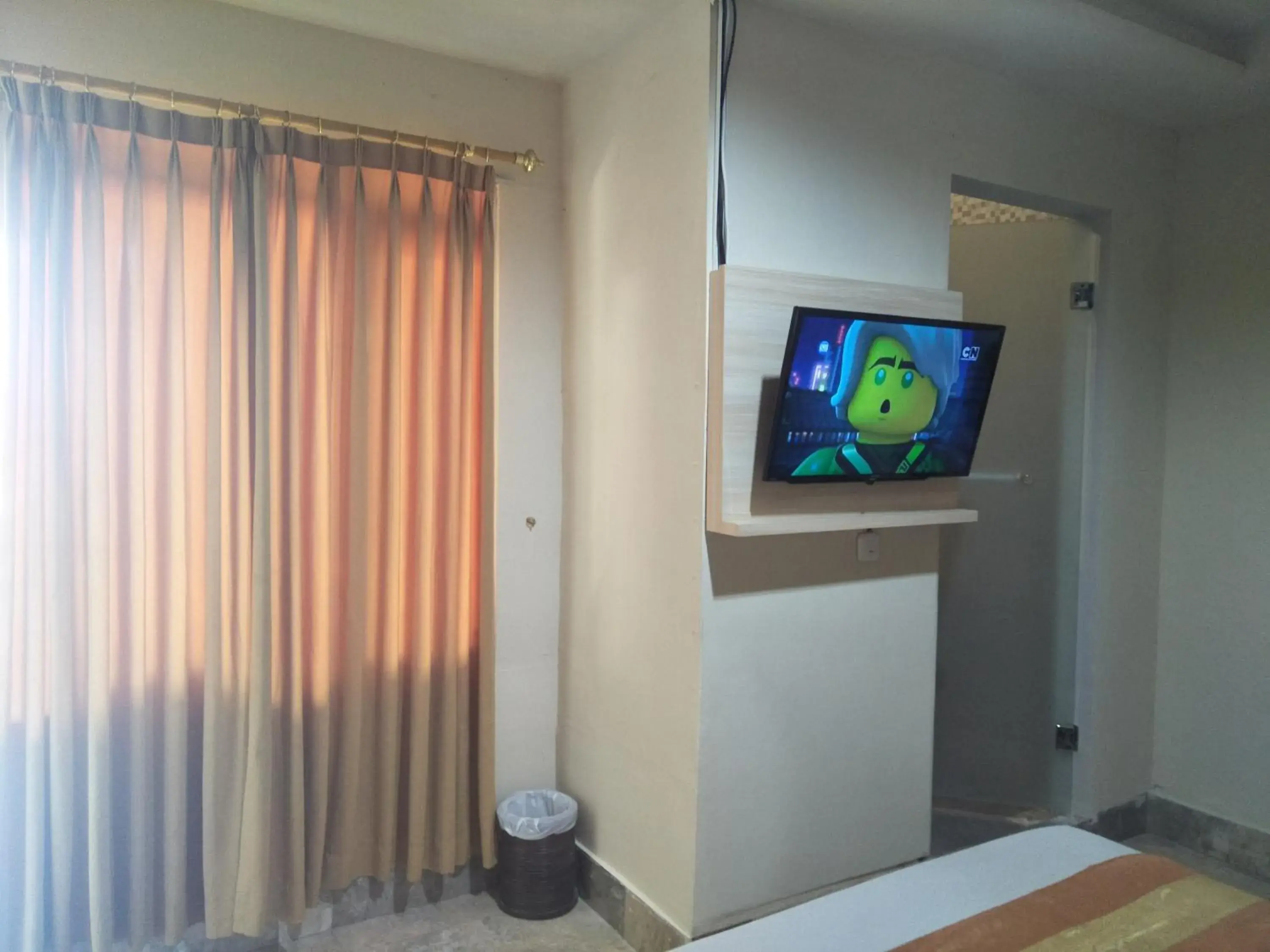 Bed, TV/Entertainment Center in Hotel Grand Rosela Yogyakarta