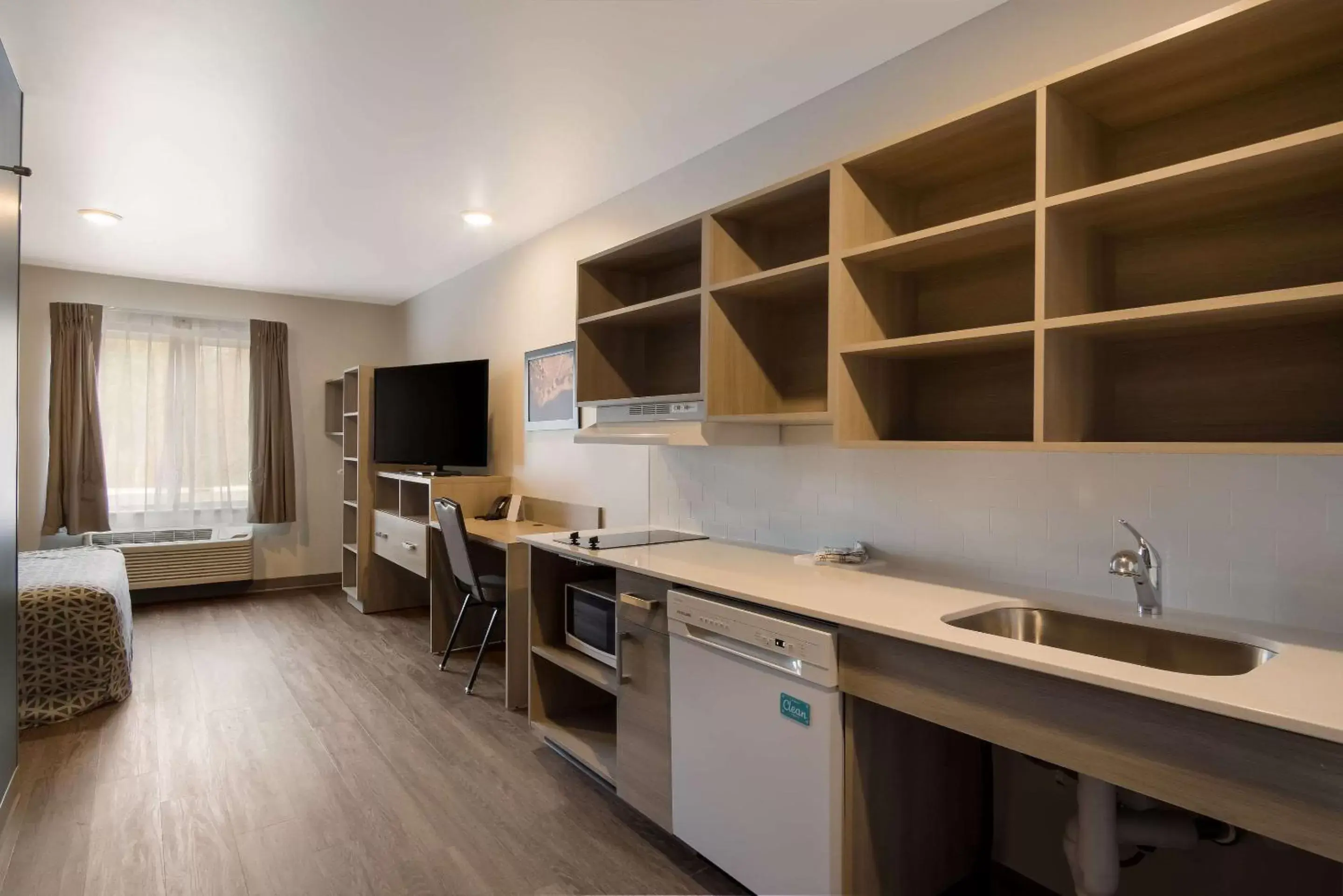 Bedroom, Kitchen/Kitchenette in WoodSpring Suites Grand Rapids Kentwood