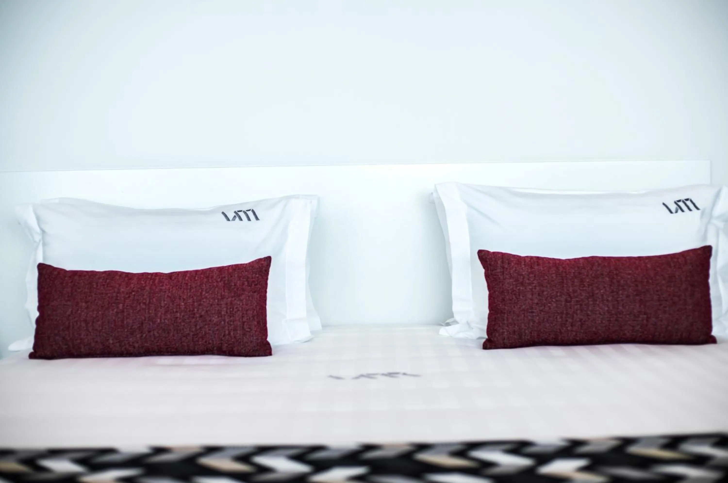 Bed in 1866 Court & Suites Hotel