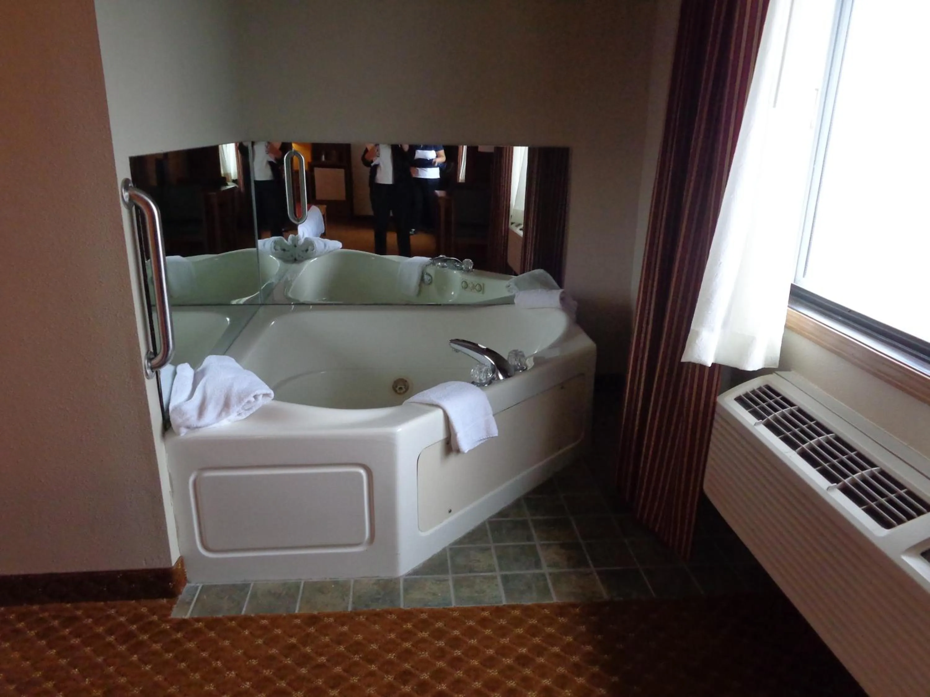 Decorative detail, Bed in AmericInn by Wyndham Coralville