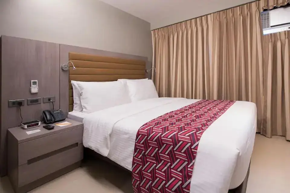 Bed in Solace Hotel Makati