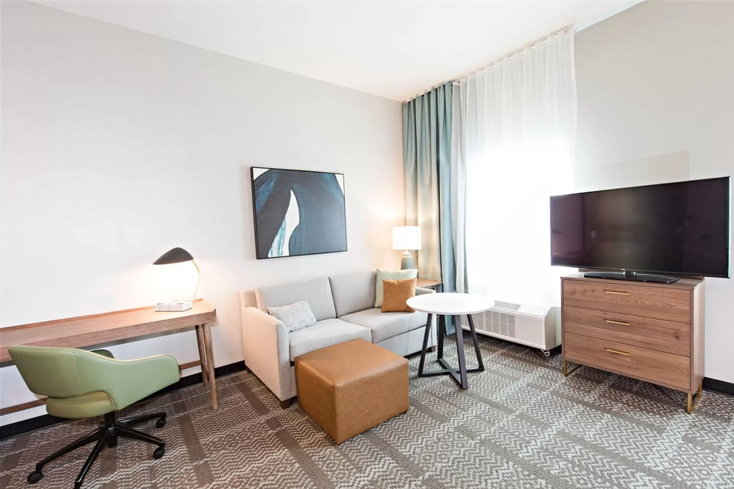 Bedroom, TV/Entertainment Center in Staybridge Suites - Denver North - Thornton, an IHG Hotel