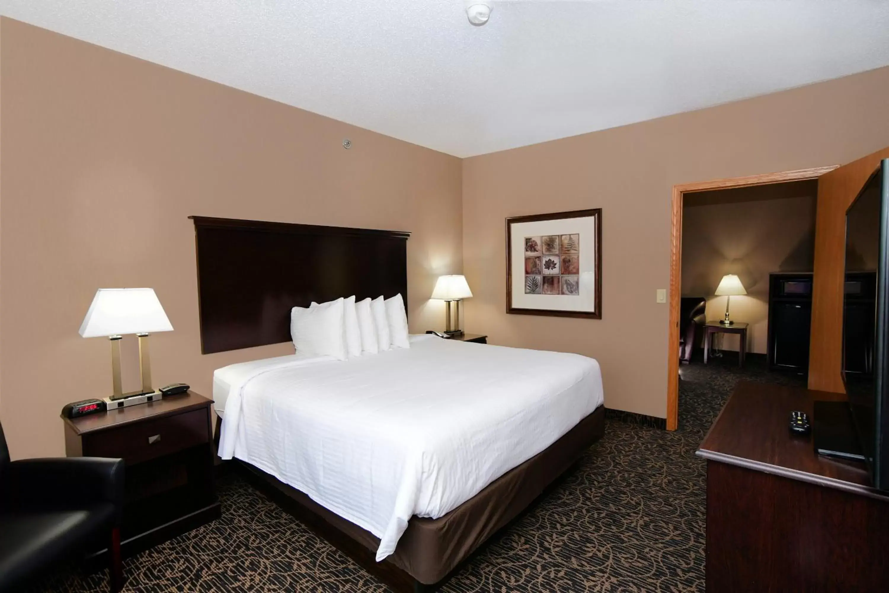 Bed in Cobblestone Inn & Suites - Denison | Majestic Hills