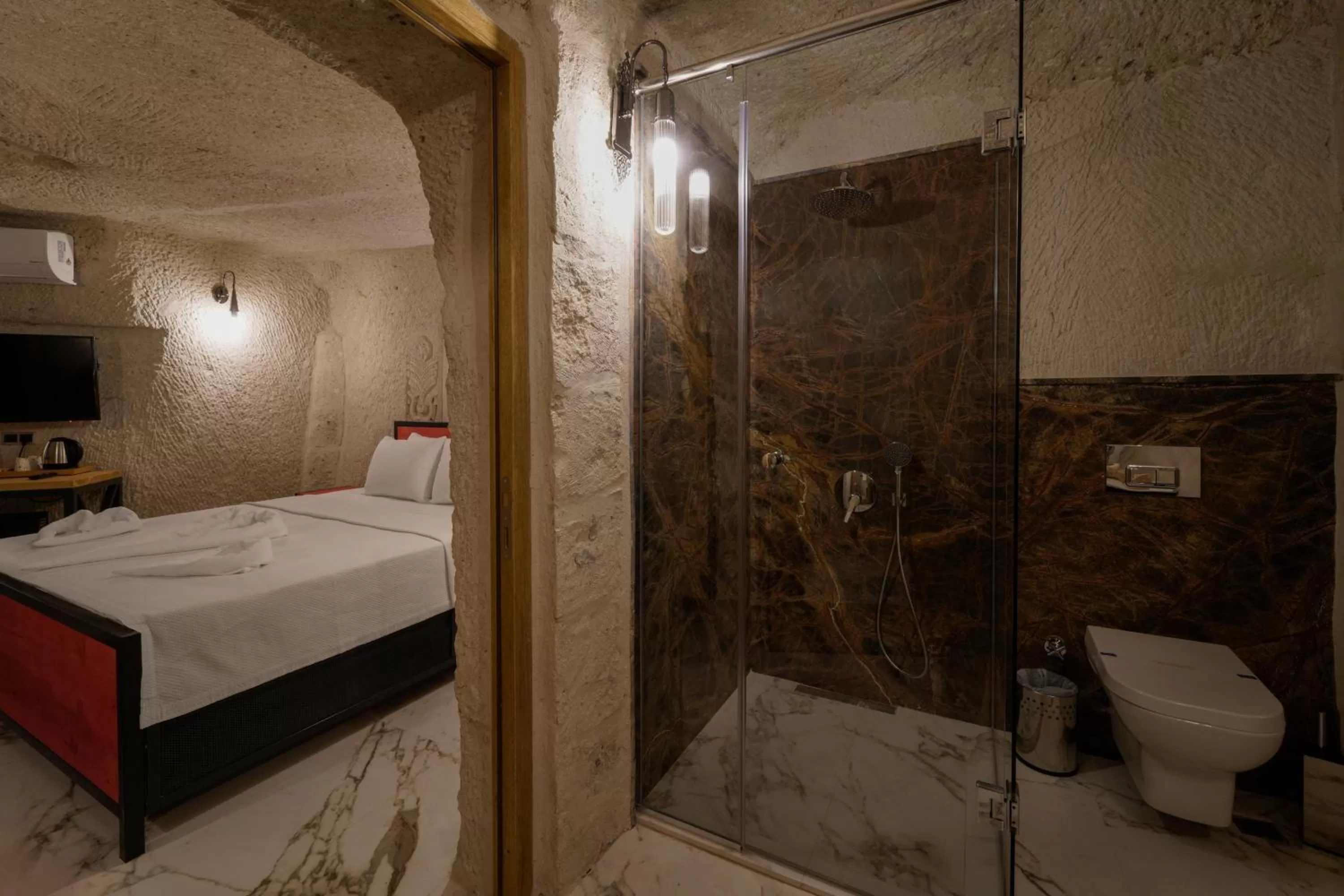 Shower, Bed in The Niche Cave Hotel