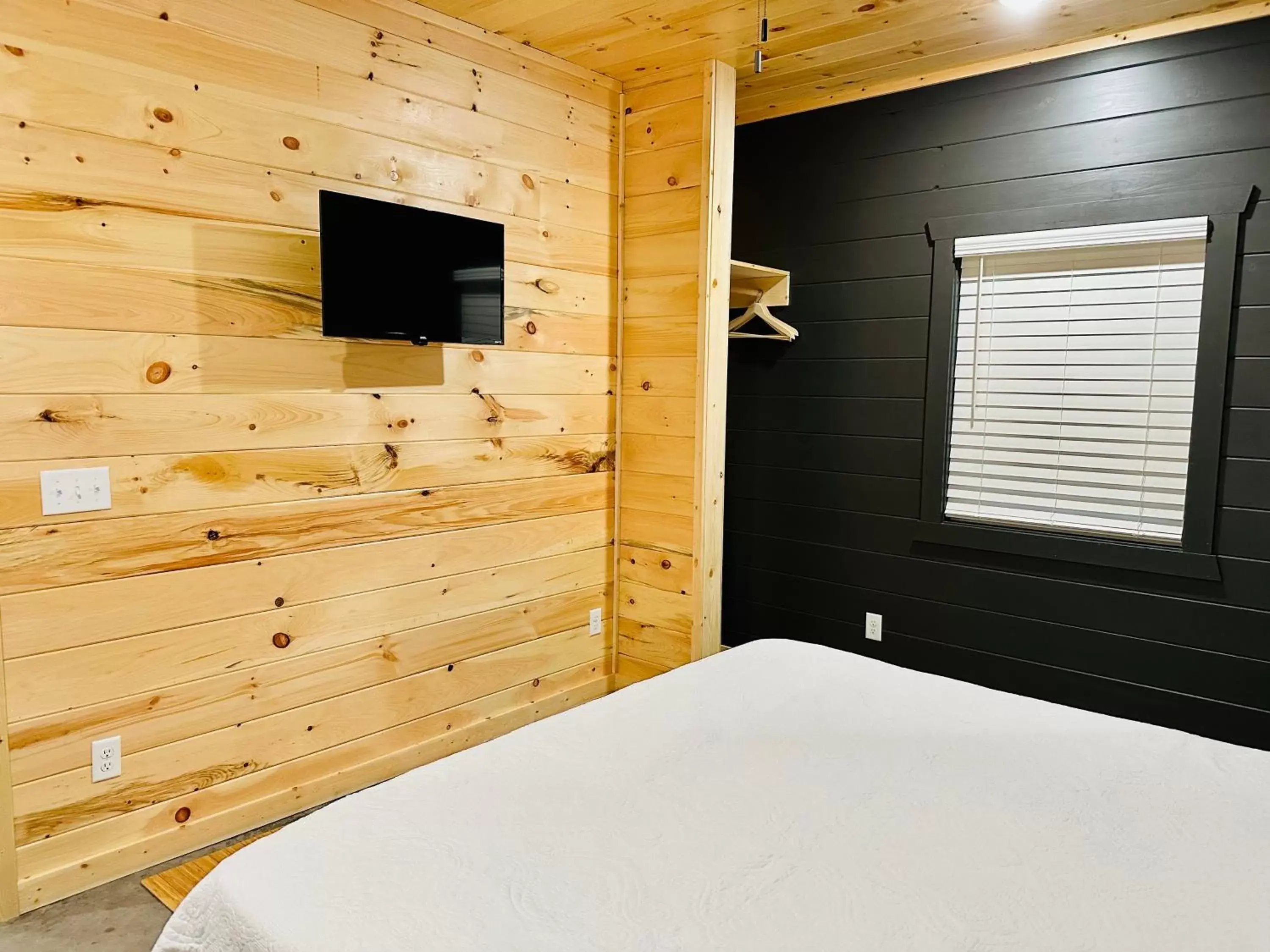 Bedroom, TV/Entertainment Center in Knotty Squirrel Cabins