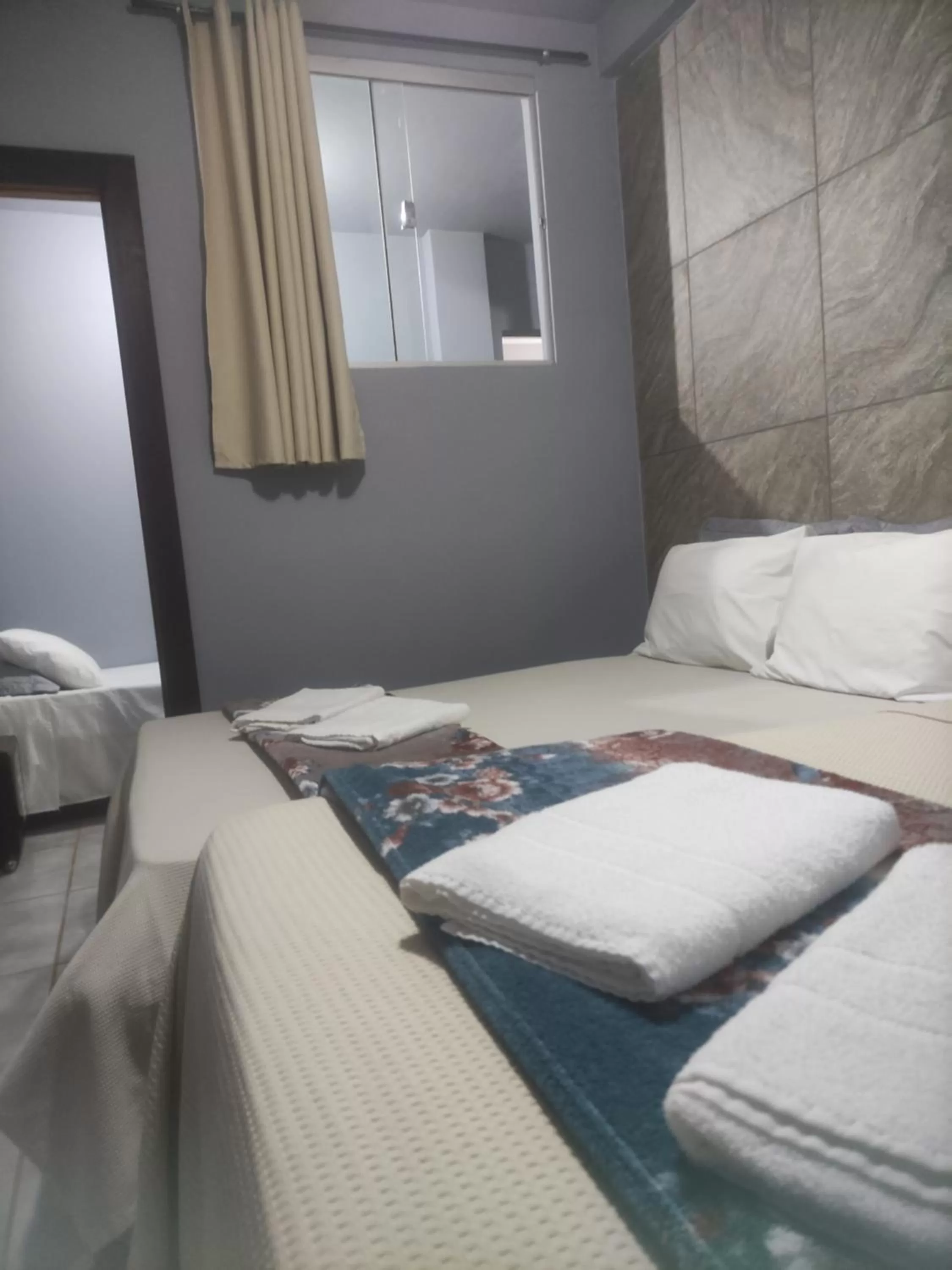 Bed in Pousada da Gi Suítes e Turismo