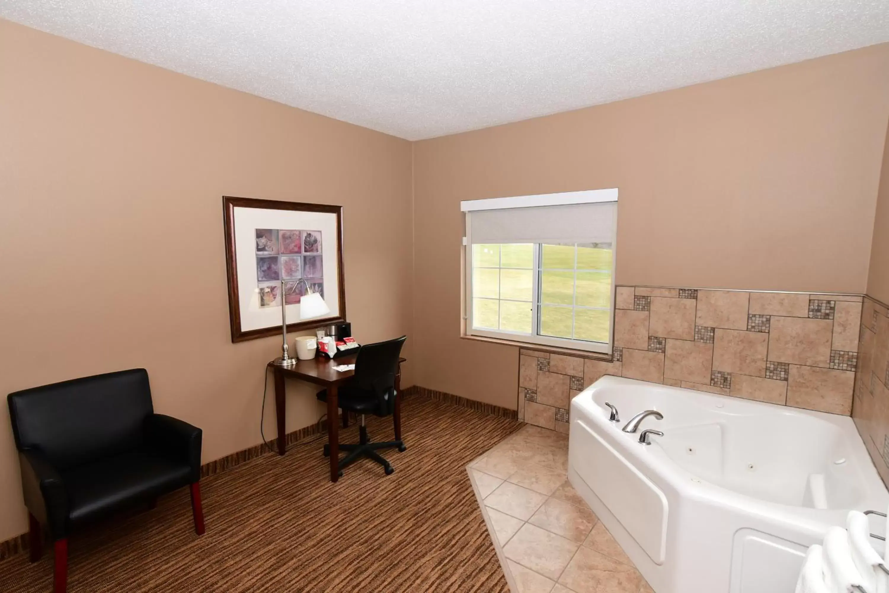 Bedroom in Cobblestone Inn & Suites - Denison | Majestic Hills