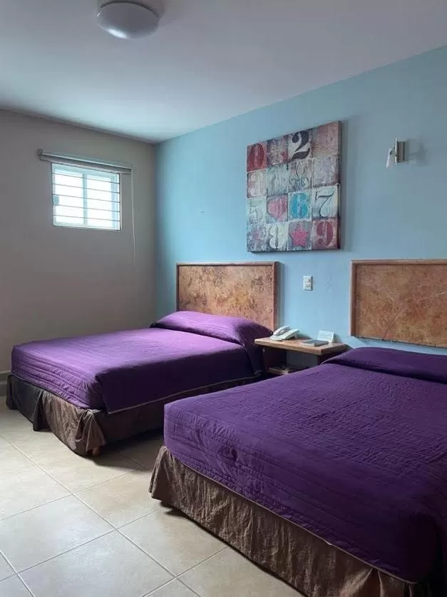 Bed in Hotel Santo Domingo Express