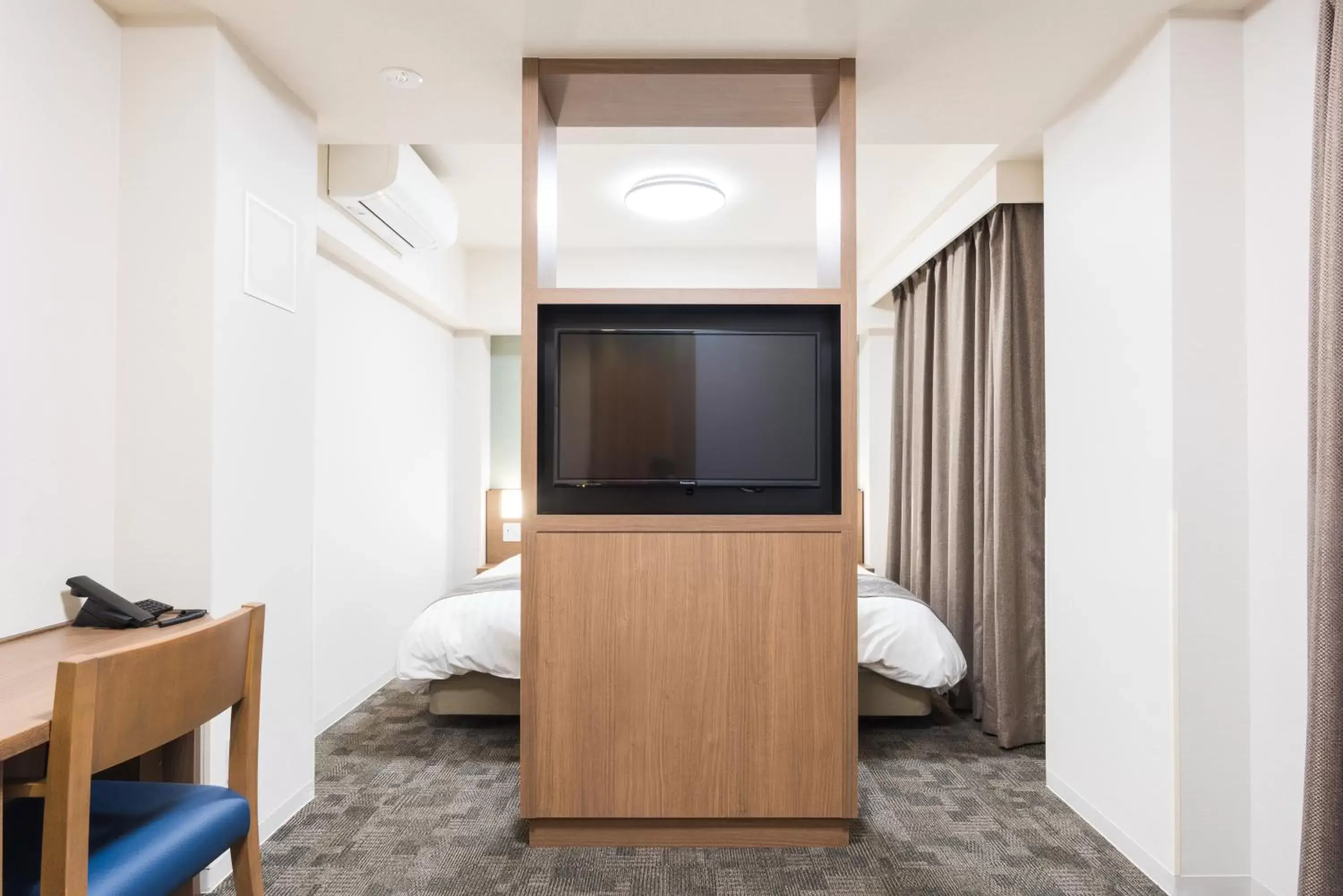 Bedroom, TV/Entertainment Center in Dormy Inn EXPRESS Sendai Seaside