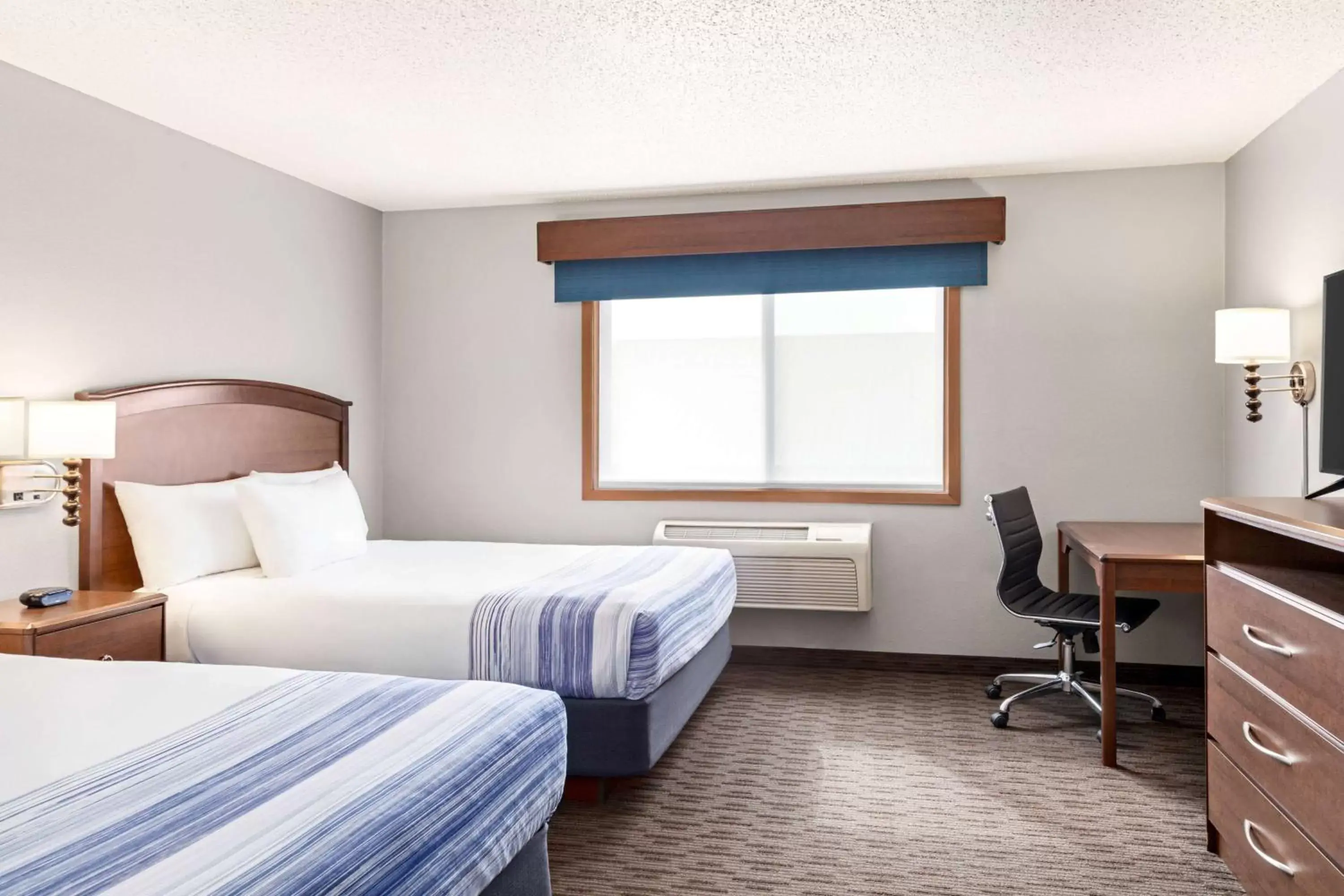 Bed in AmericInn by Wyndham Sauk Centre